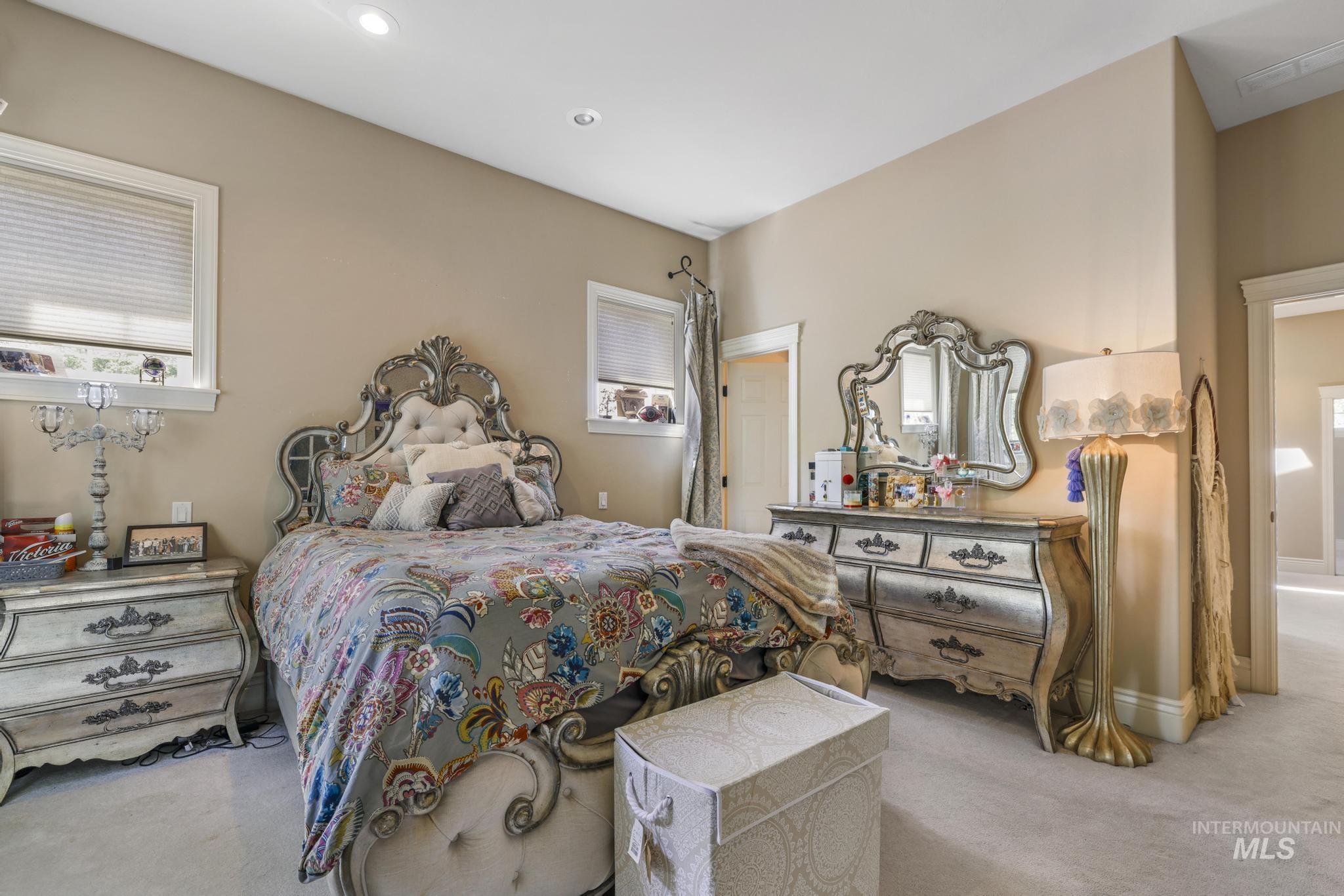 Bedroom with carpet flooring, multiple windows, and recessed lighting