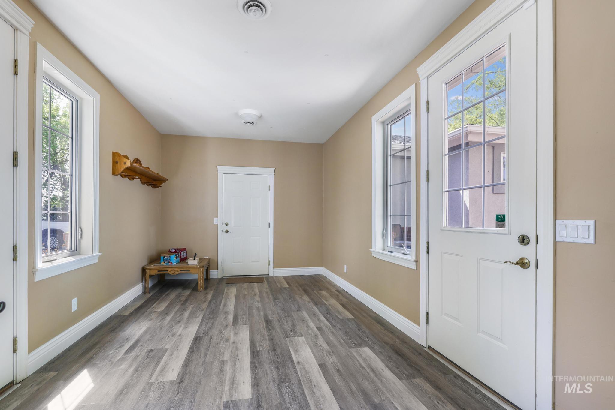 Entryway featuring baseboards and wood finished floors