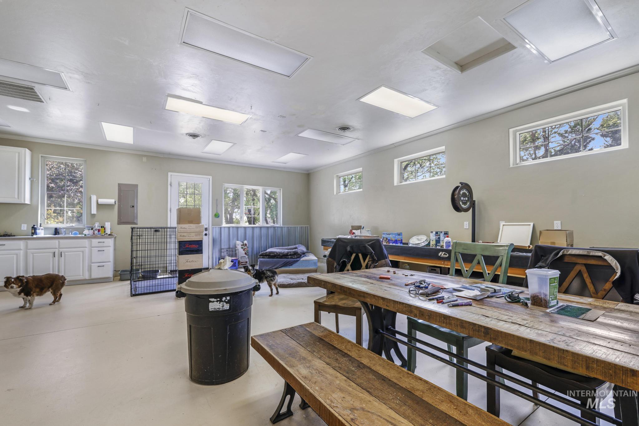 Office with concrete flooring, healthy amount of natural light, and electric panel