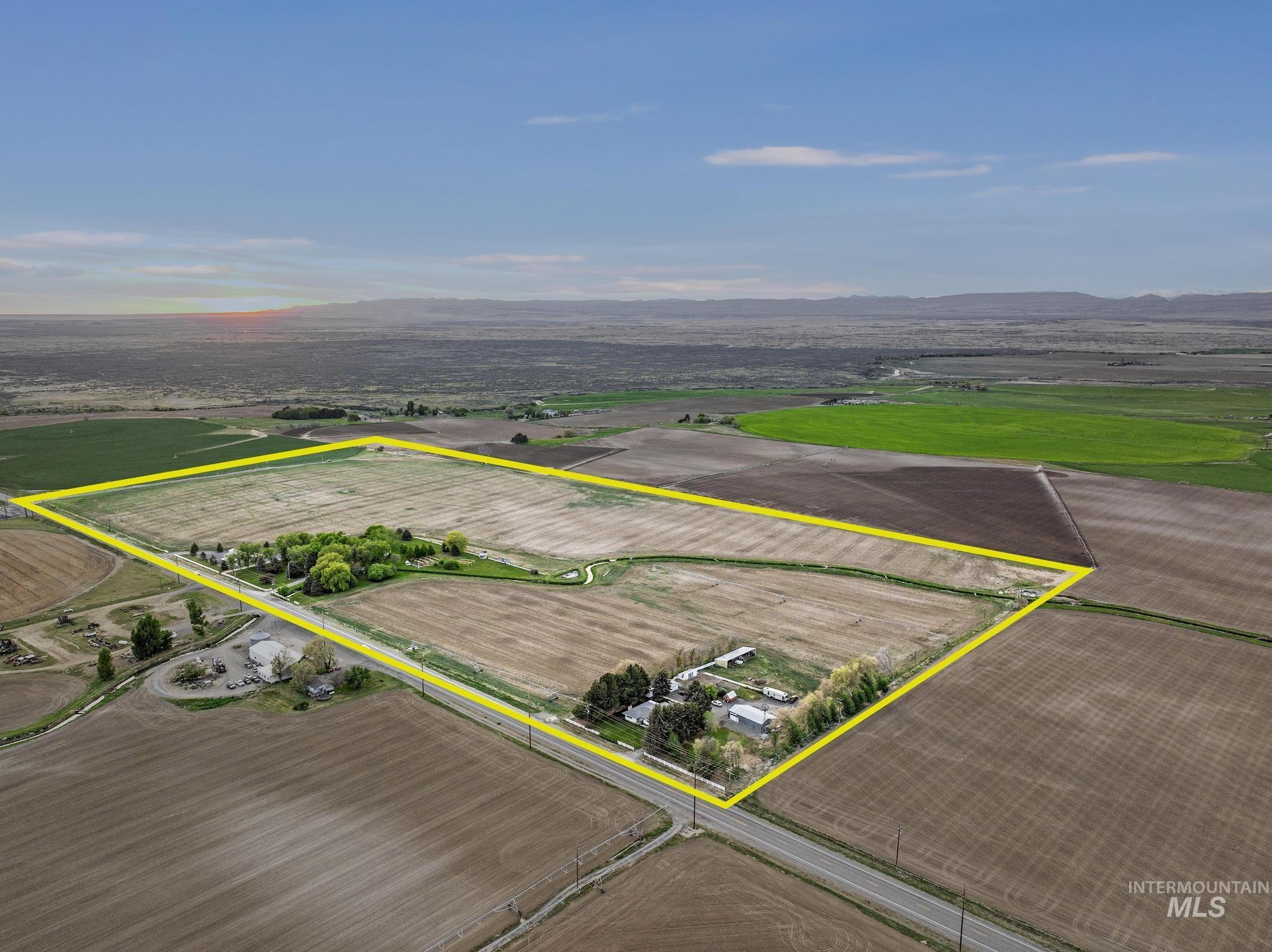 Overview of rural landscape featuring property parcel outlined and a mountainous background
