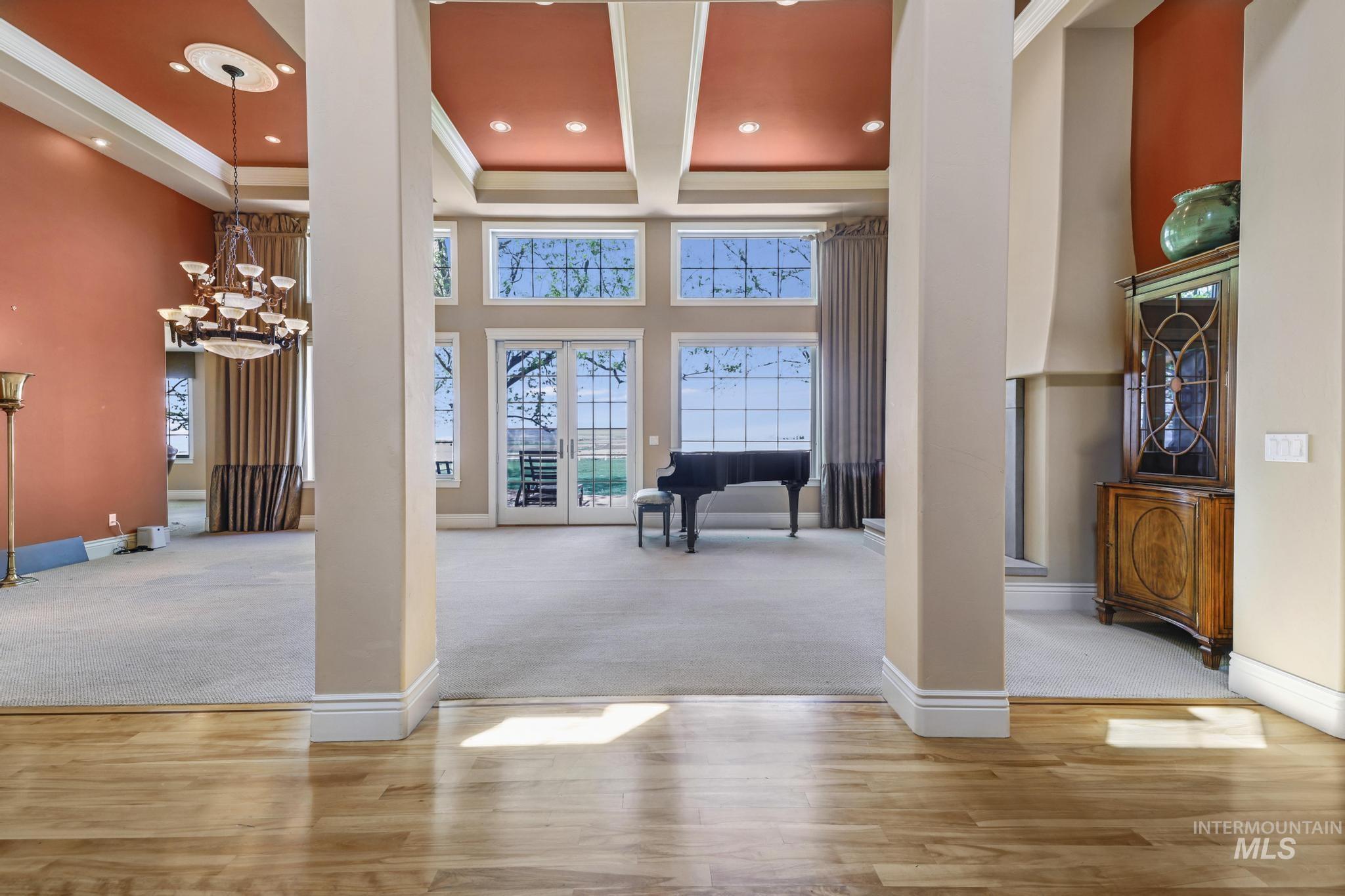 Entrance foyer with a chandelier, a high ceiling, wood finished floors, carpet flooring, and recessed lighting