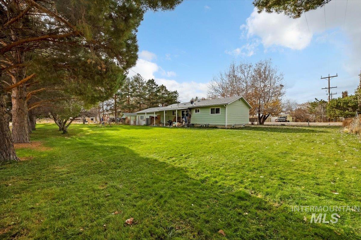 View of green lawn featuring a patio area