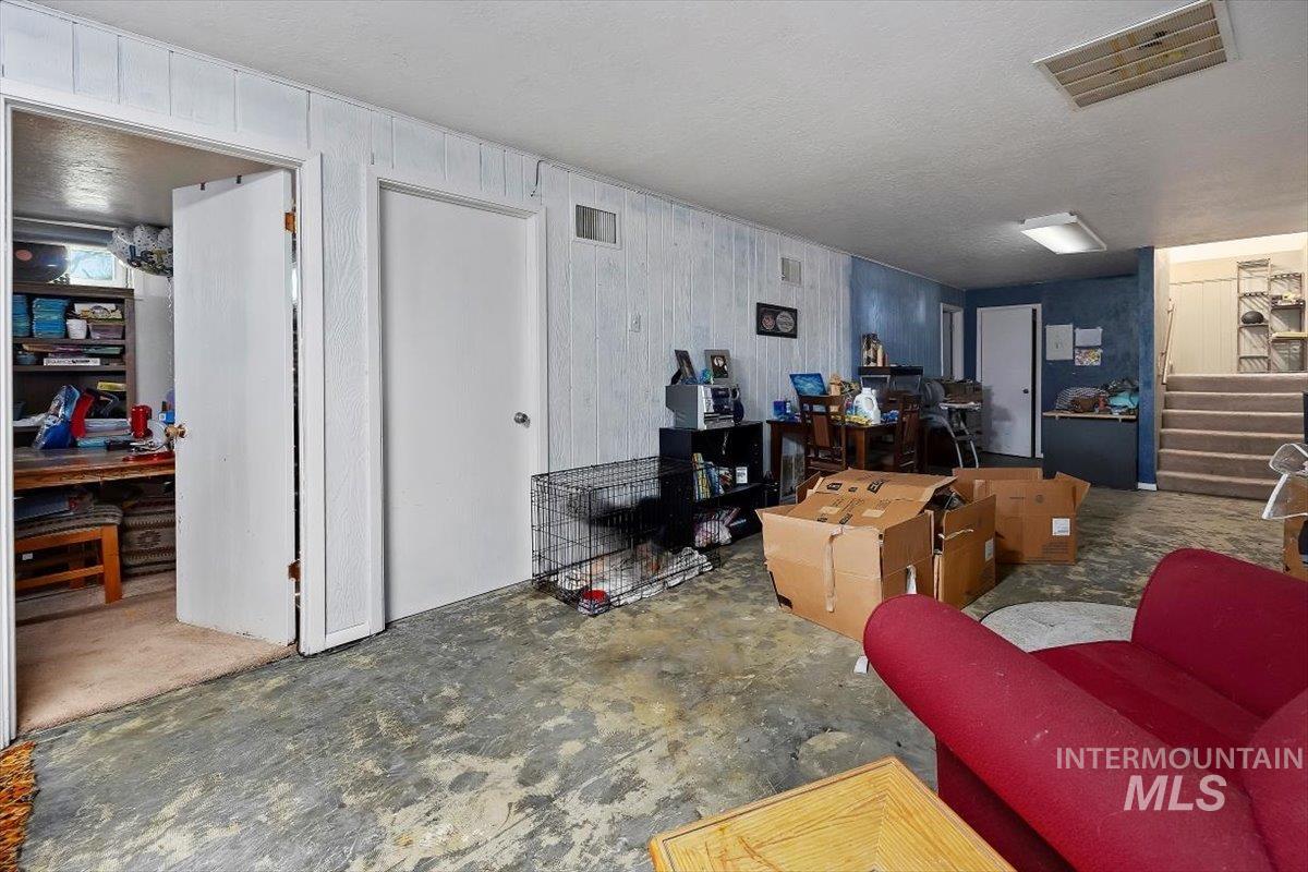 Living room with a textured ceiling and stairs