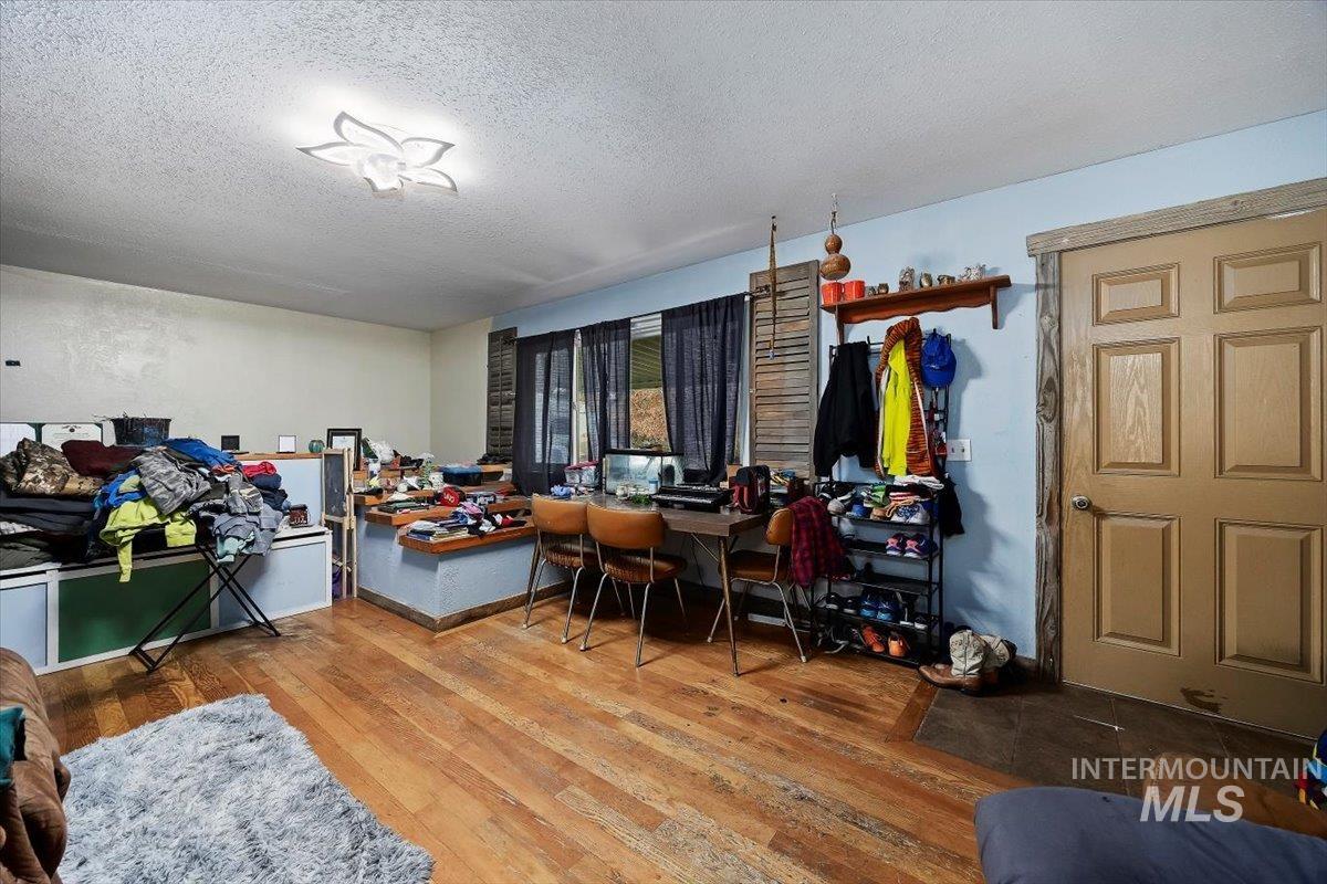 Dining room with hardwood / wood-style flooring, a textured ceiling, and a desk