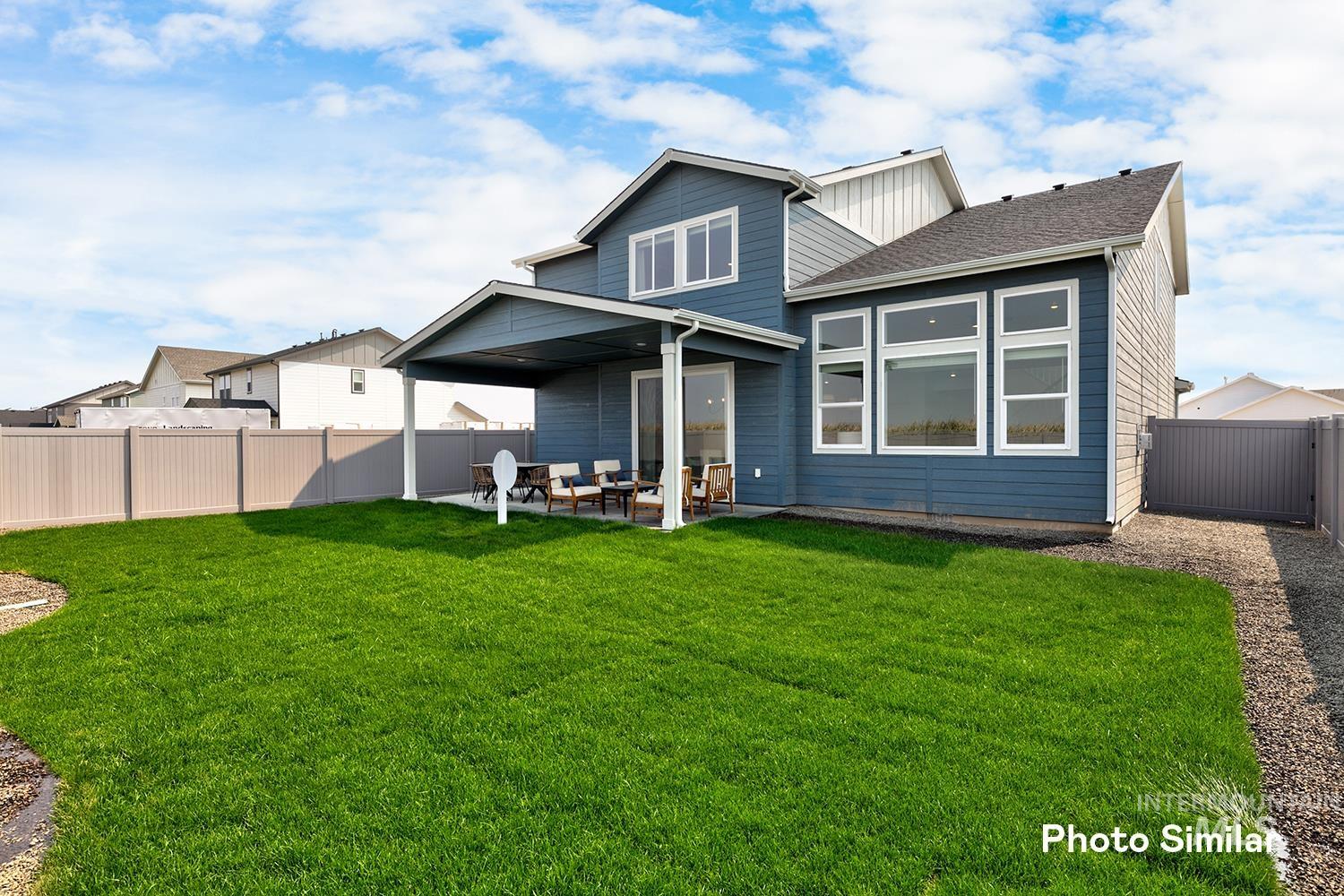 Rear view of house featuring a patio, a fenced backyard, roof with shingles, and outdoor lounge area