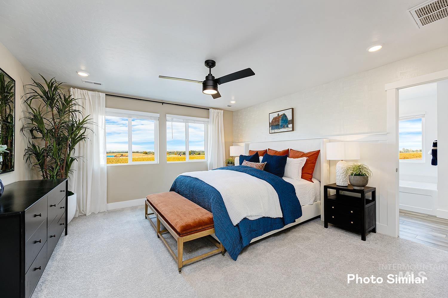 Carpeted bedroom featuring a ceiling fan and recessed lighting