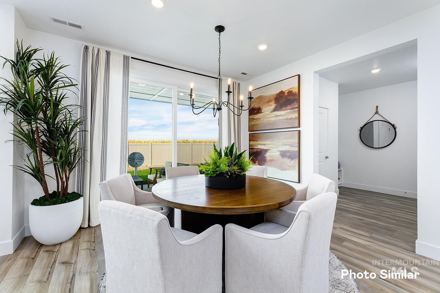 Dining space featuring light wood finished floors, a chandelier, and recessed lighting