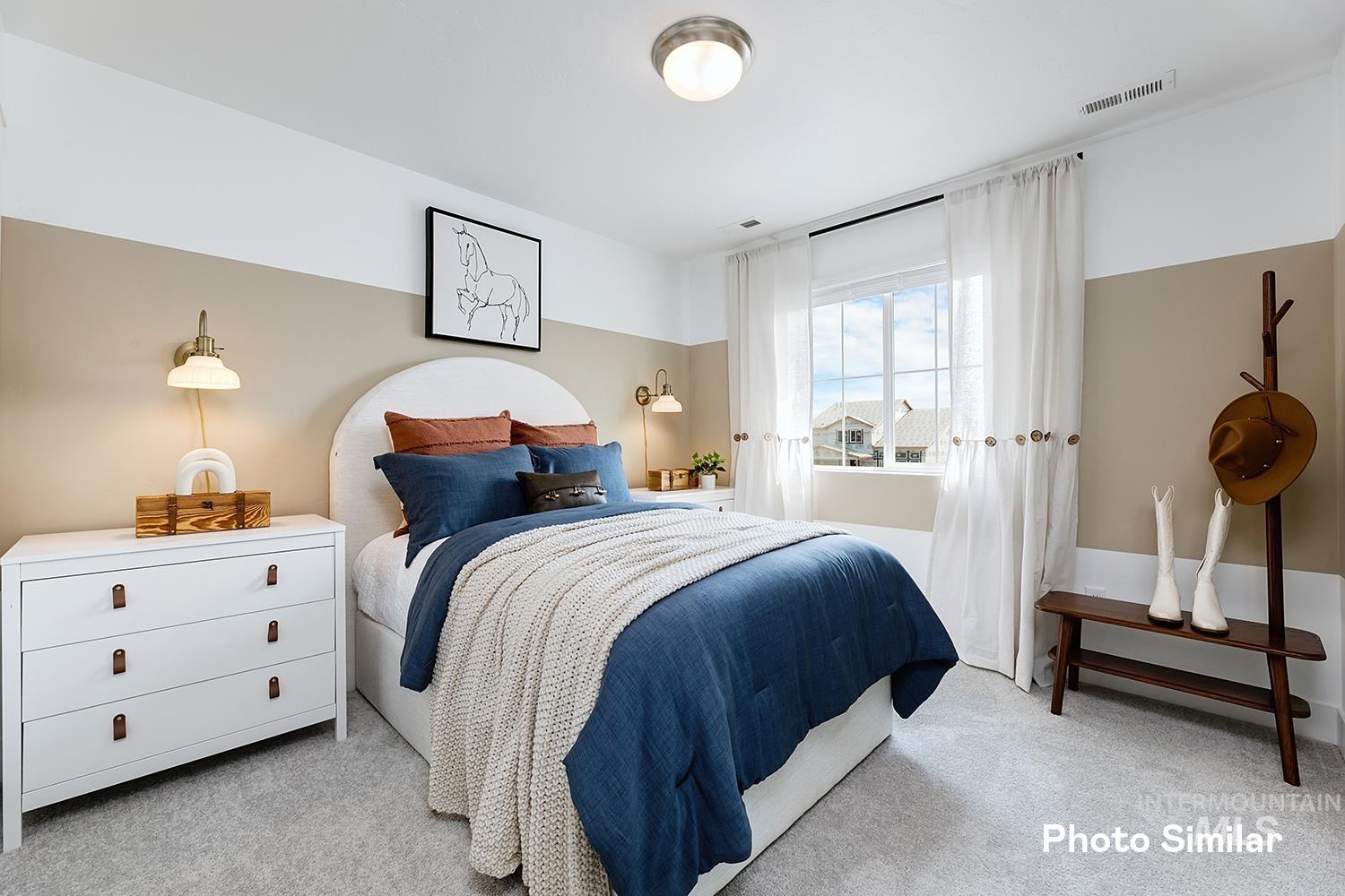Bedroom featuring light colored carpet