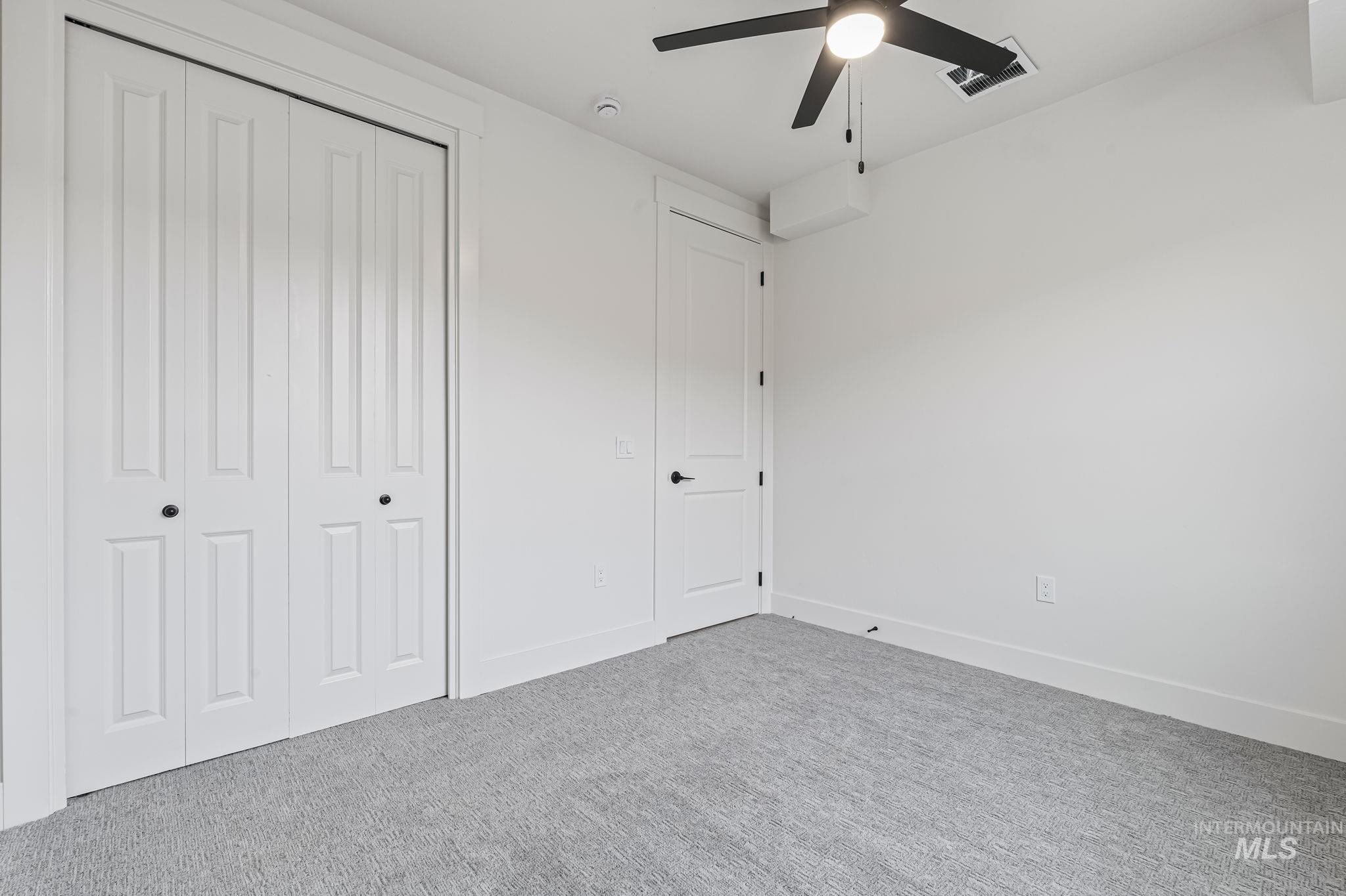Unfurnished bedroom featuring a closet, a ceiling fan, and carpet flooring