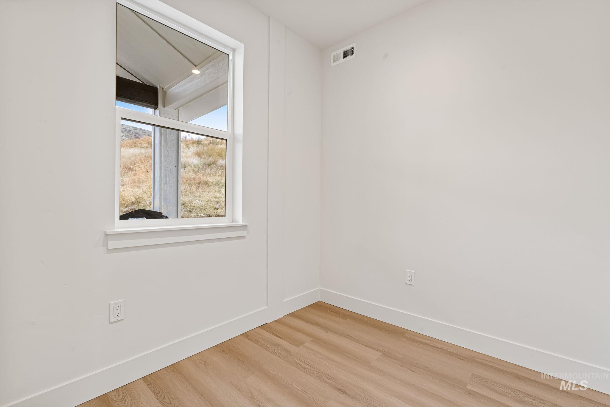 Den/ Office featuring wood finished floors and baseboards