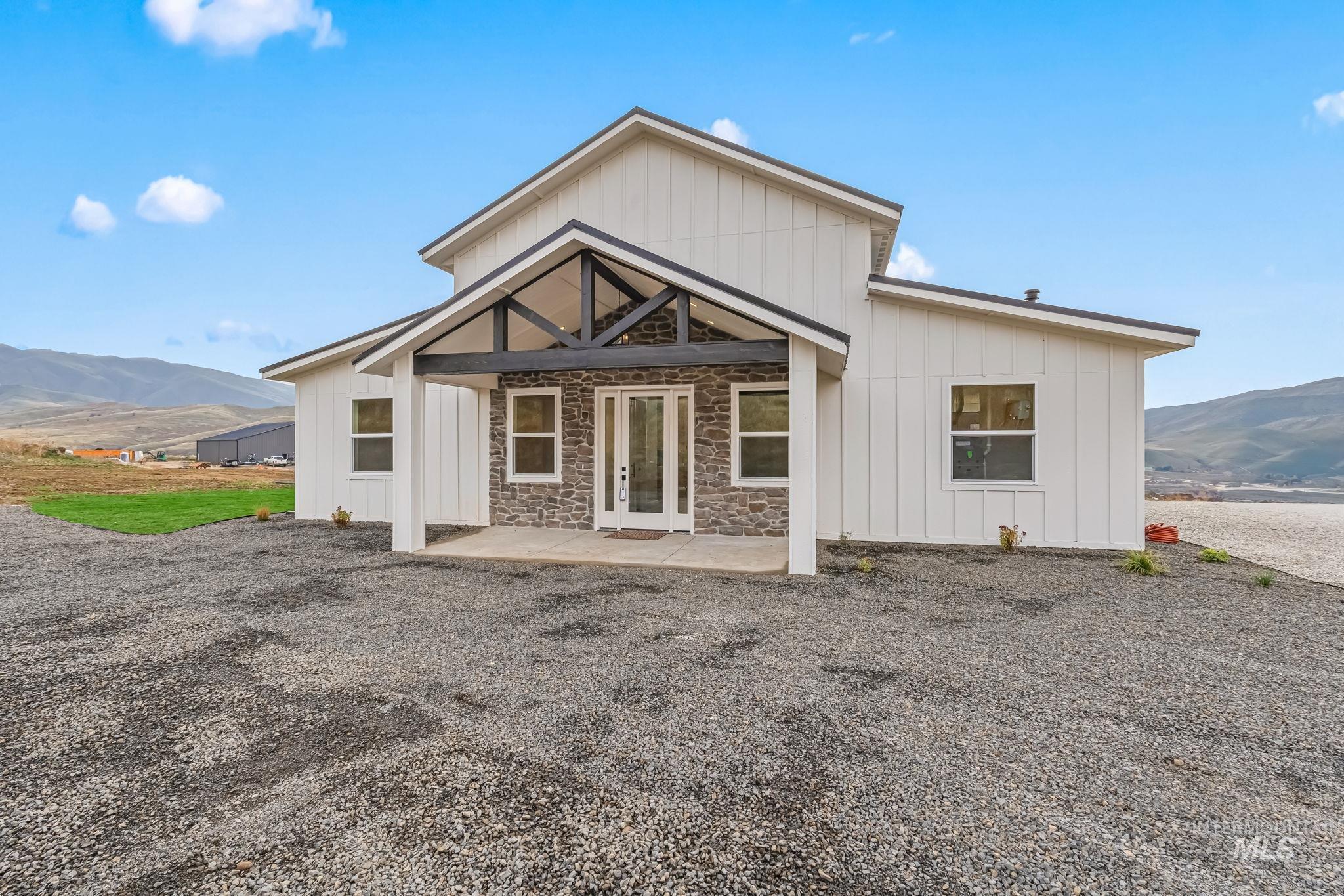 Front entry featuring a mountain view, board and batten siding, and french doors