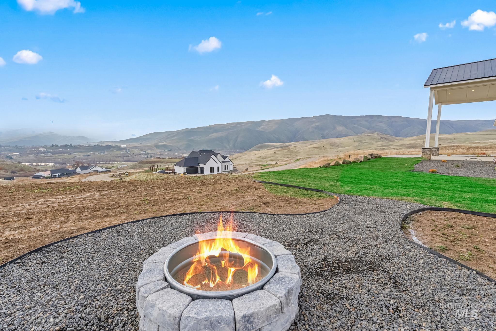 View of green lawn featuring a mountain view