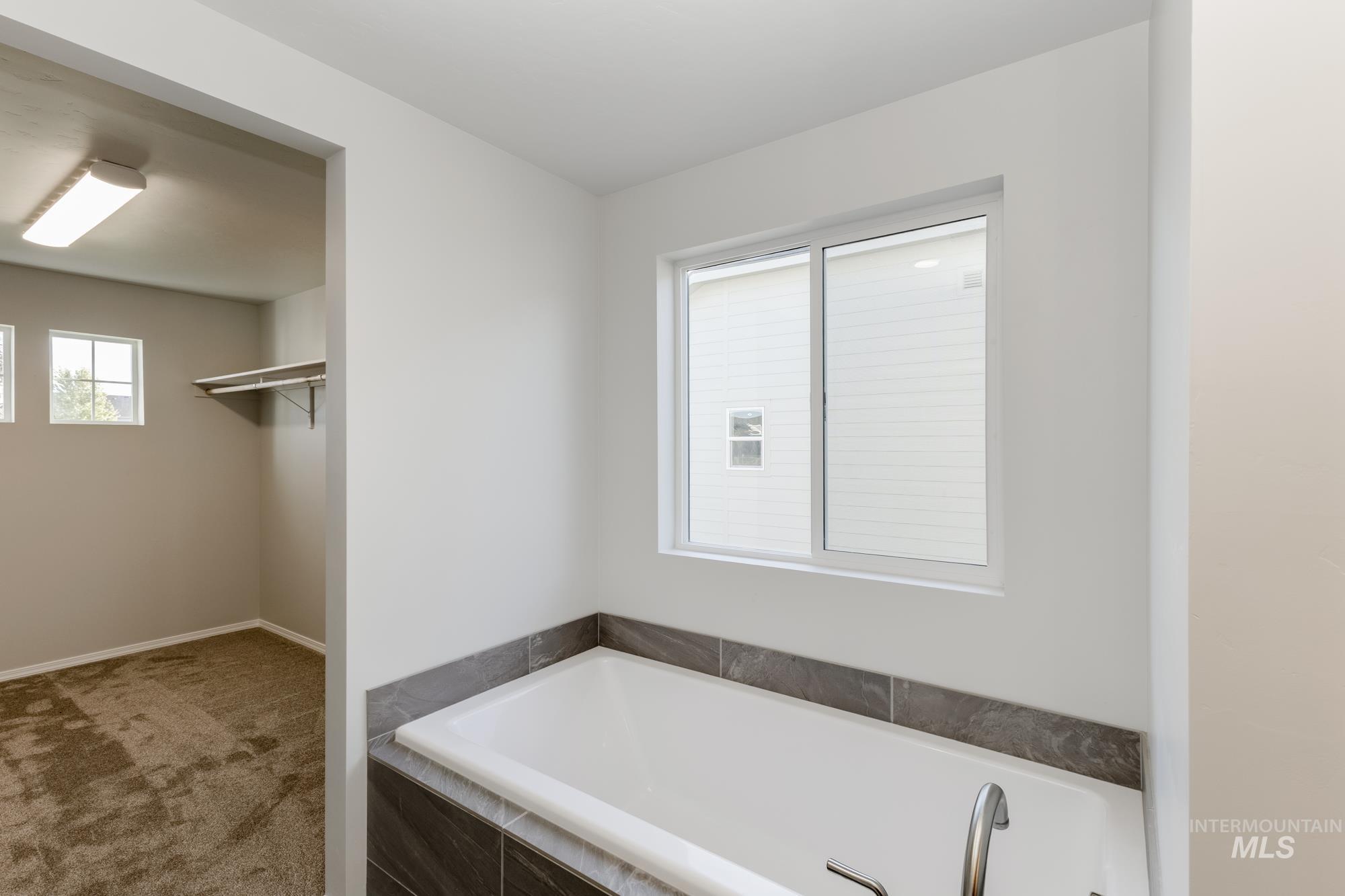Full bath featuring a garden tub