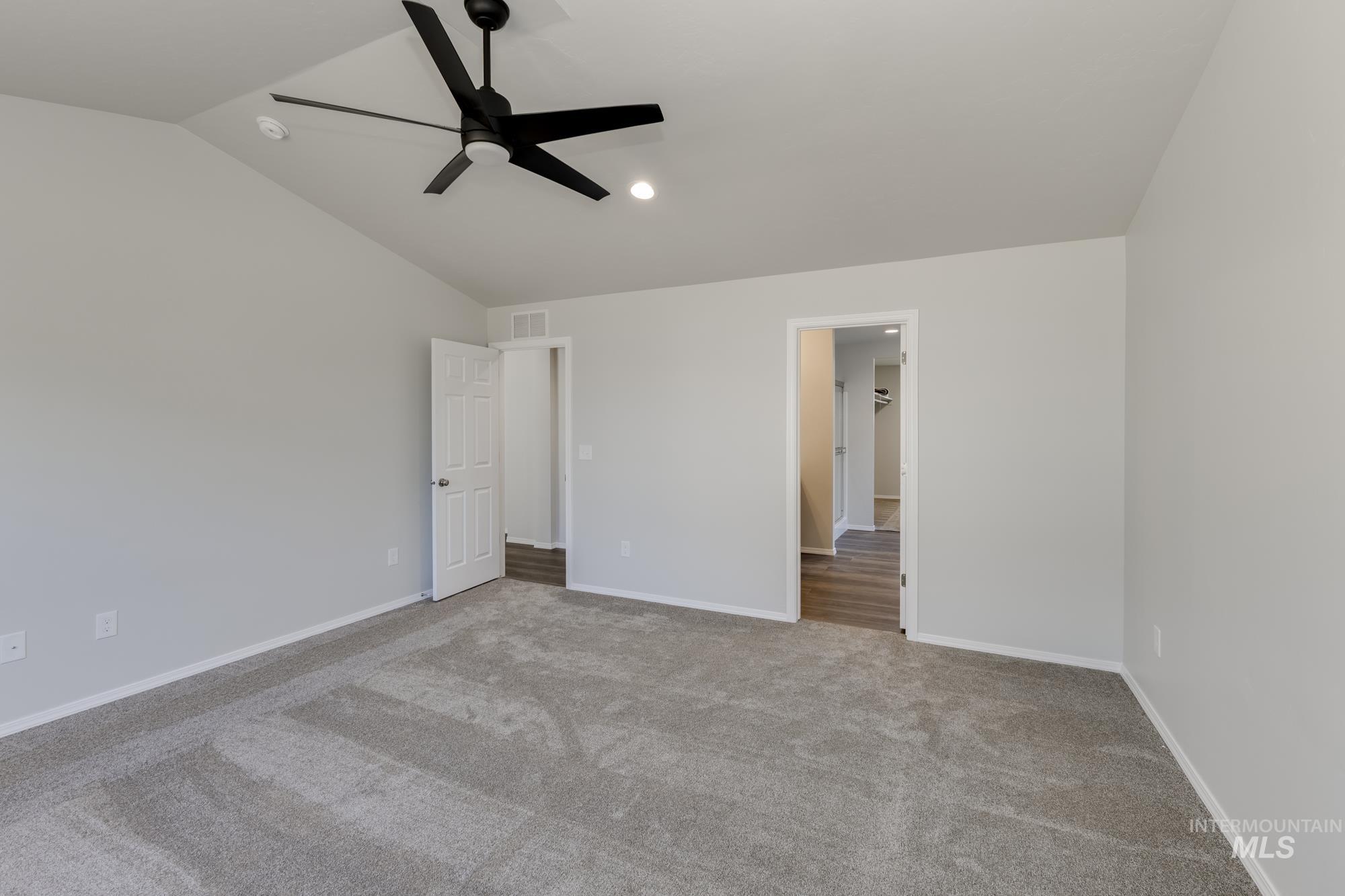 Unfurnished bedroom featuring lofted ceiling, carpet floors, recessed lighting, and ceiling fan