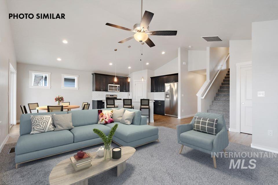 Open-concept living space featuring vaulted ceilings and recessed lighting