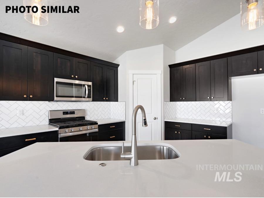 Kitchen island featuring a stainless steel undermount sink and a gooseneck faucet