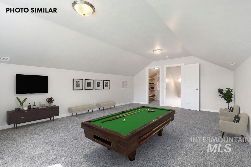 Spacious bonus room featuring vaulted ceilings, recessed lighting, and soft gray carpeting