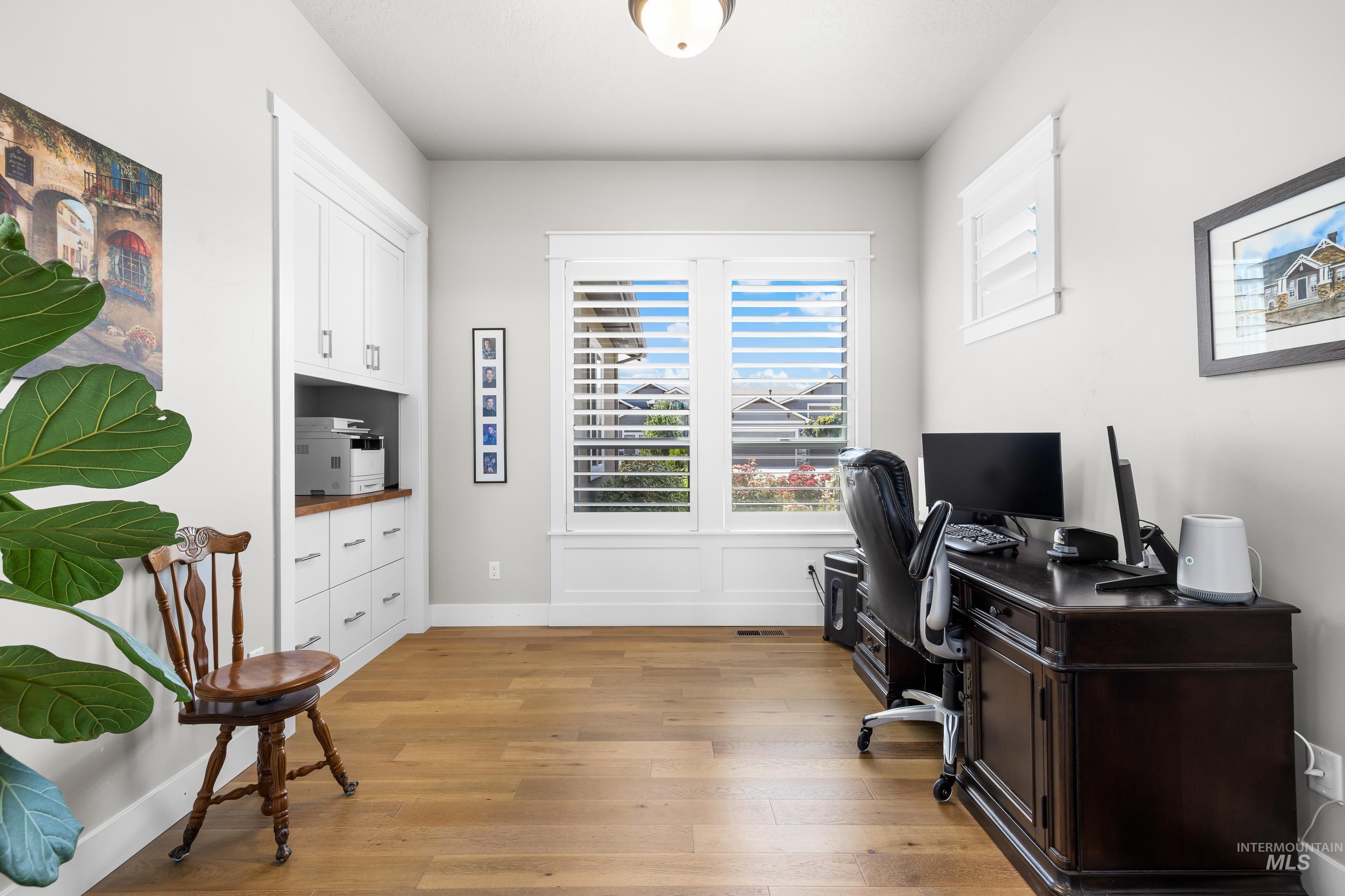 Office space featuring light wood finished floors and baseboards
