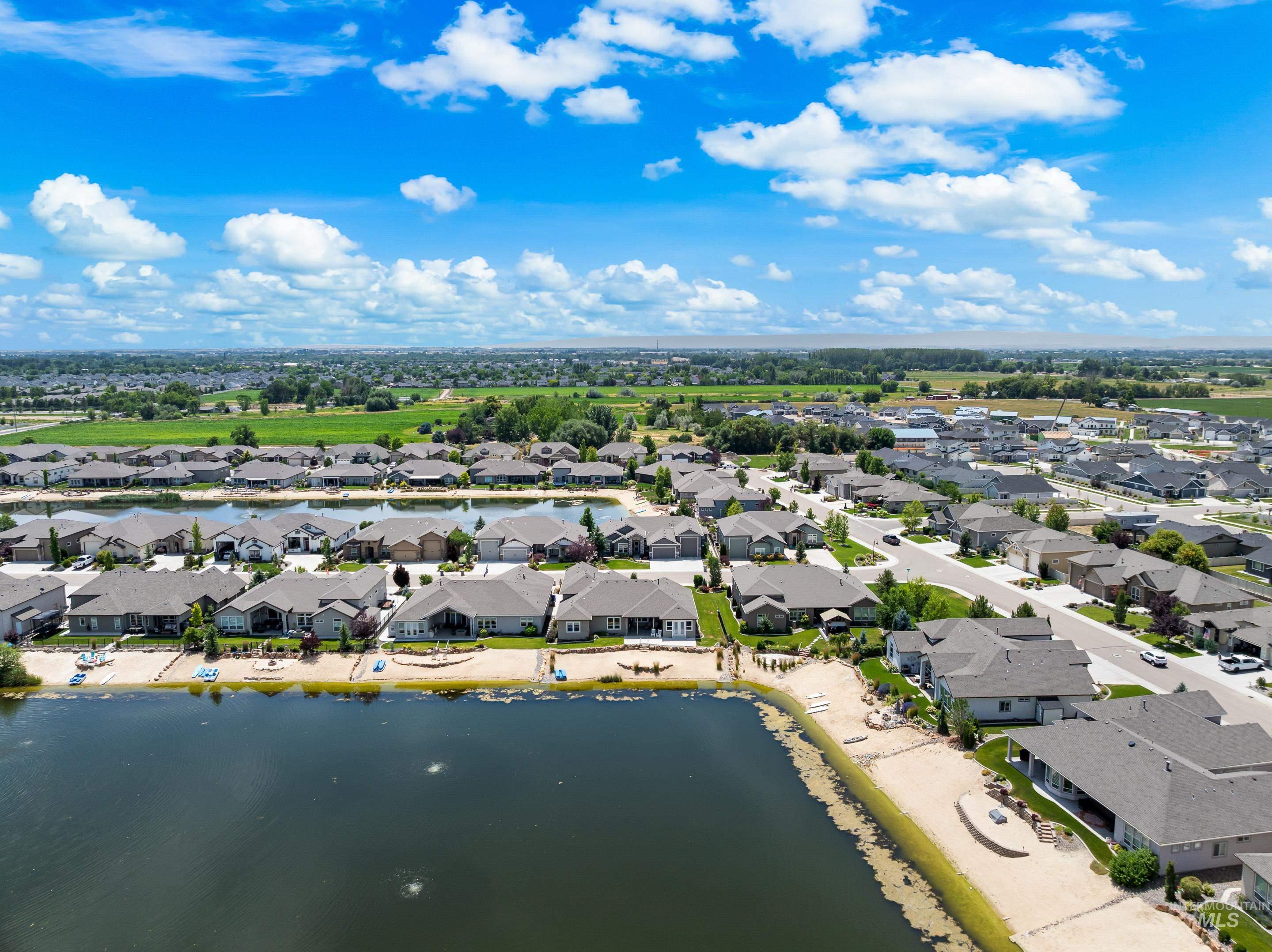 Aerial view of residential area featuring a large body of water
