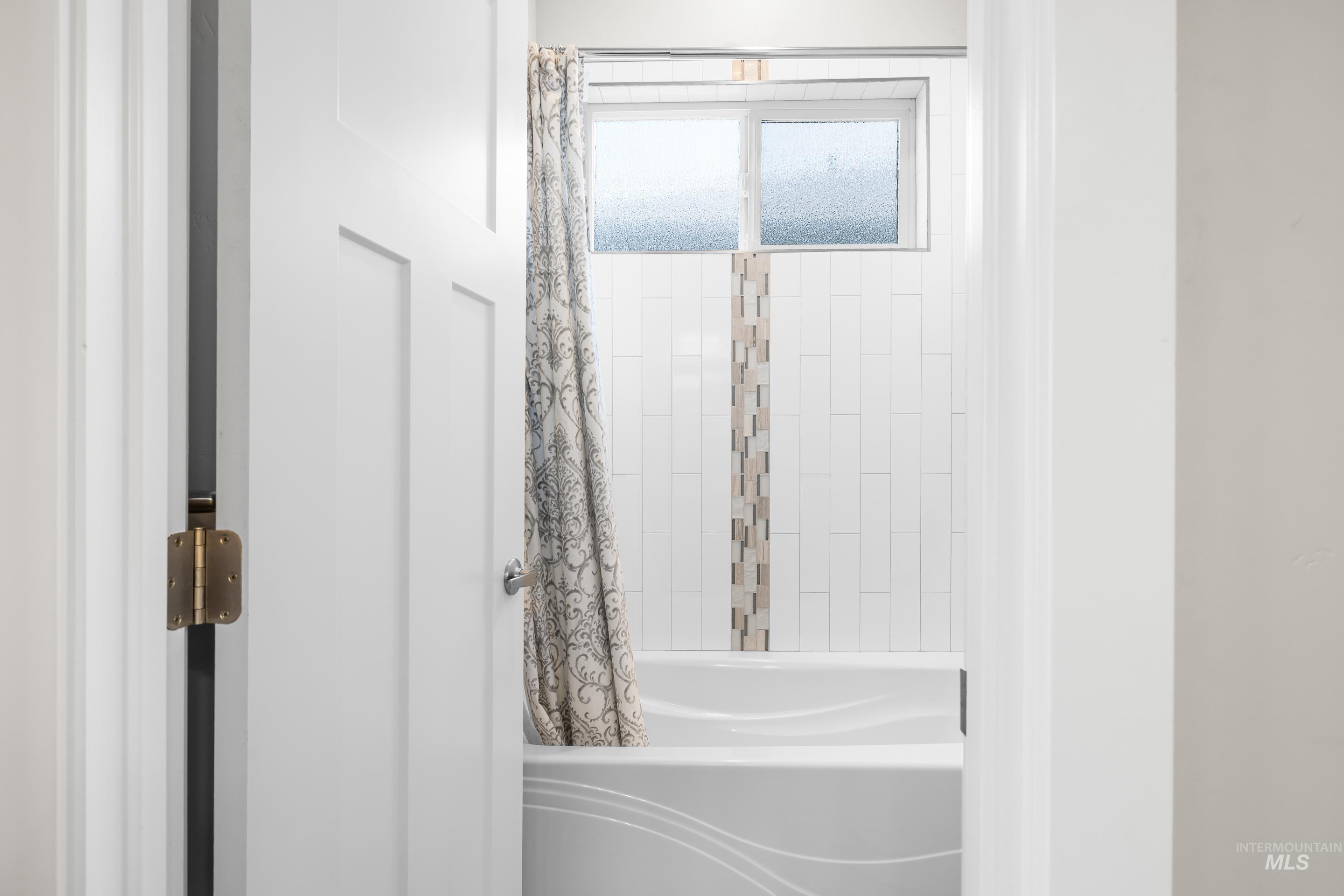 Bathroom featuring shower / tub combo with curtain