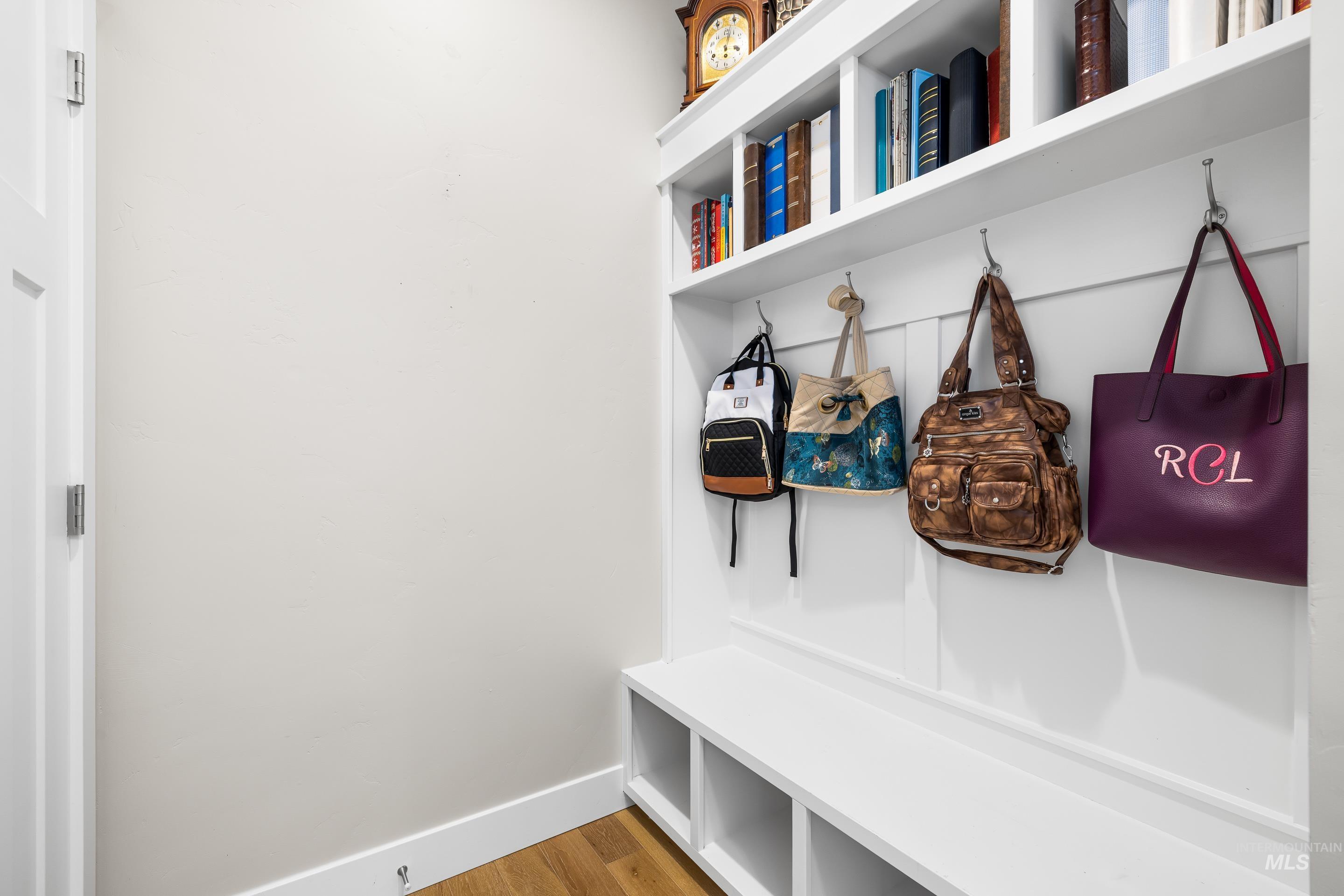 Mudroom with baseboards and light wood-type flooring