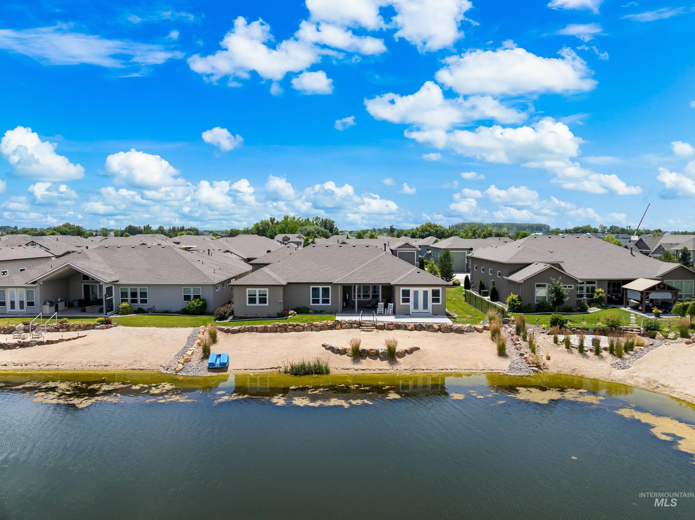 Aerial perspective of suburban area featuring a nearby body of water
