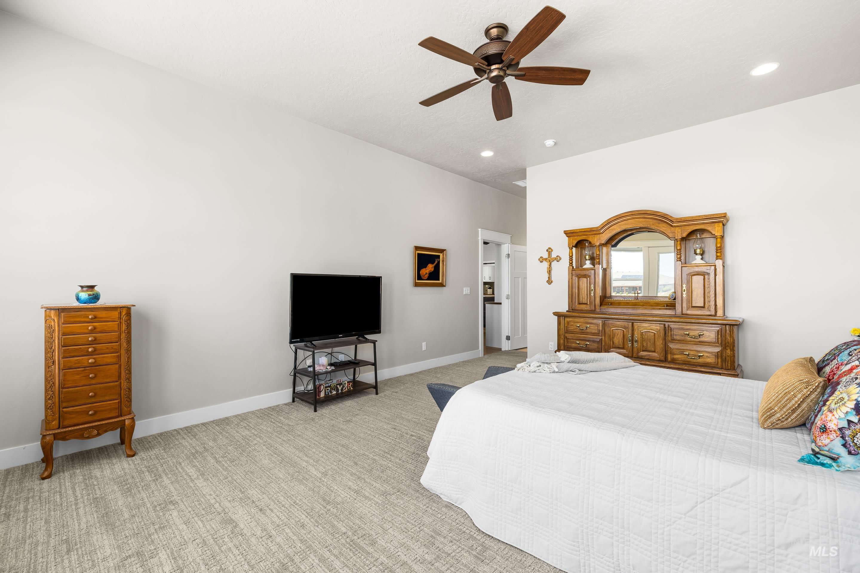 Bedroom featuring light colored carpet, recessed lighting, and ceiling fan