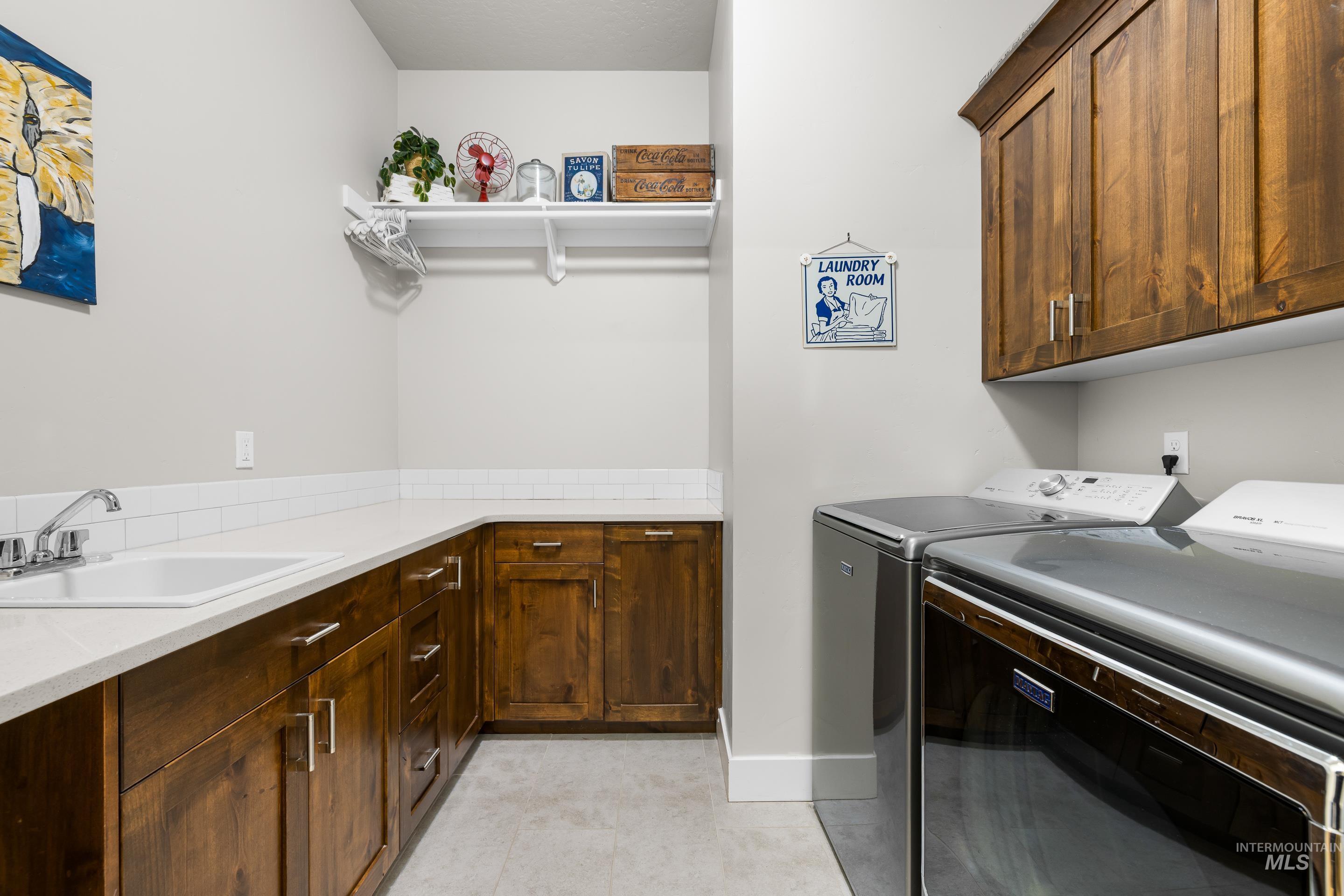 Washroom with washer and dryer and cabinet space