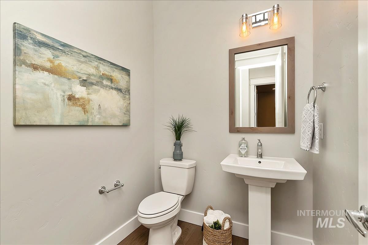 Bathroom with toilet and wood finished floors
