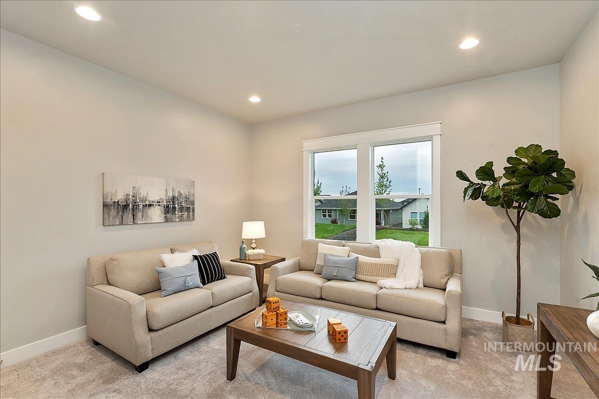 Living room with light colored carpet and recessed lighting