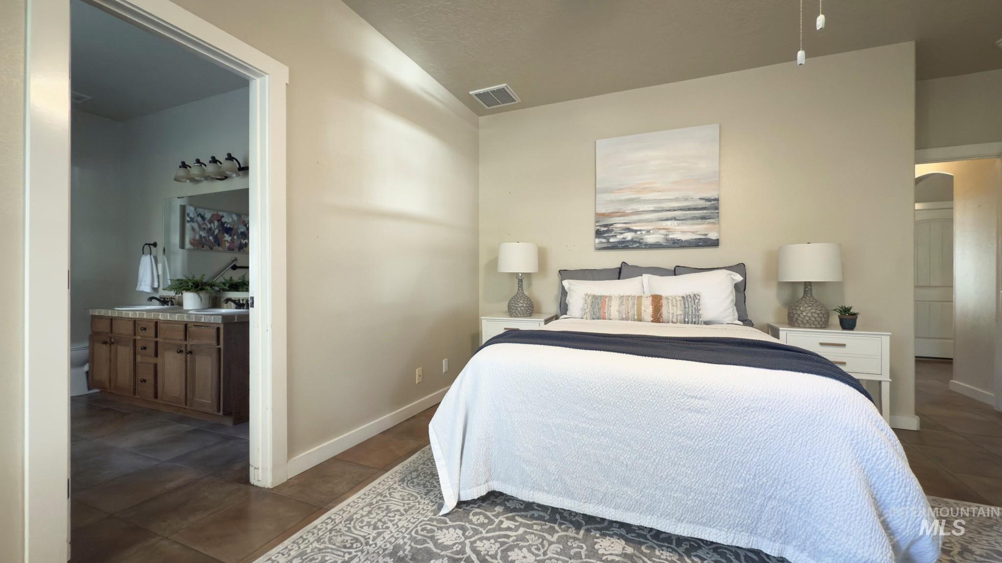 Bedroom with arched walkways and ensuite bath