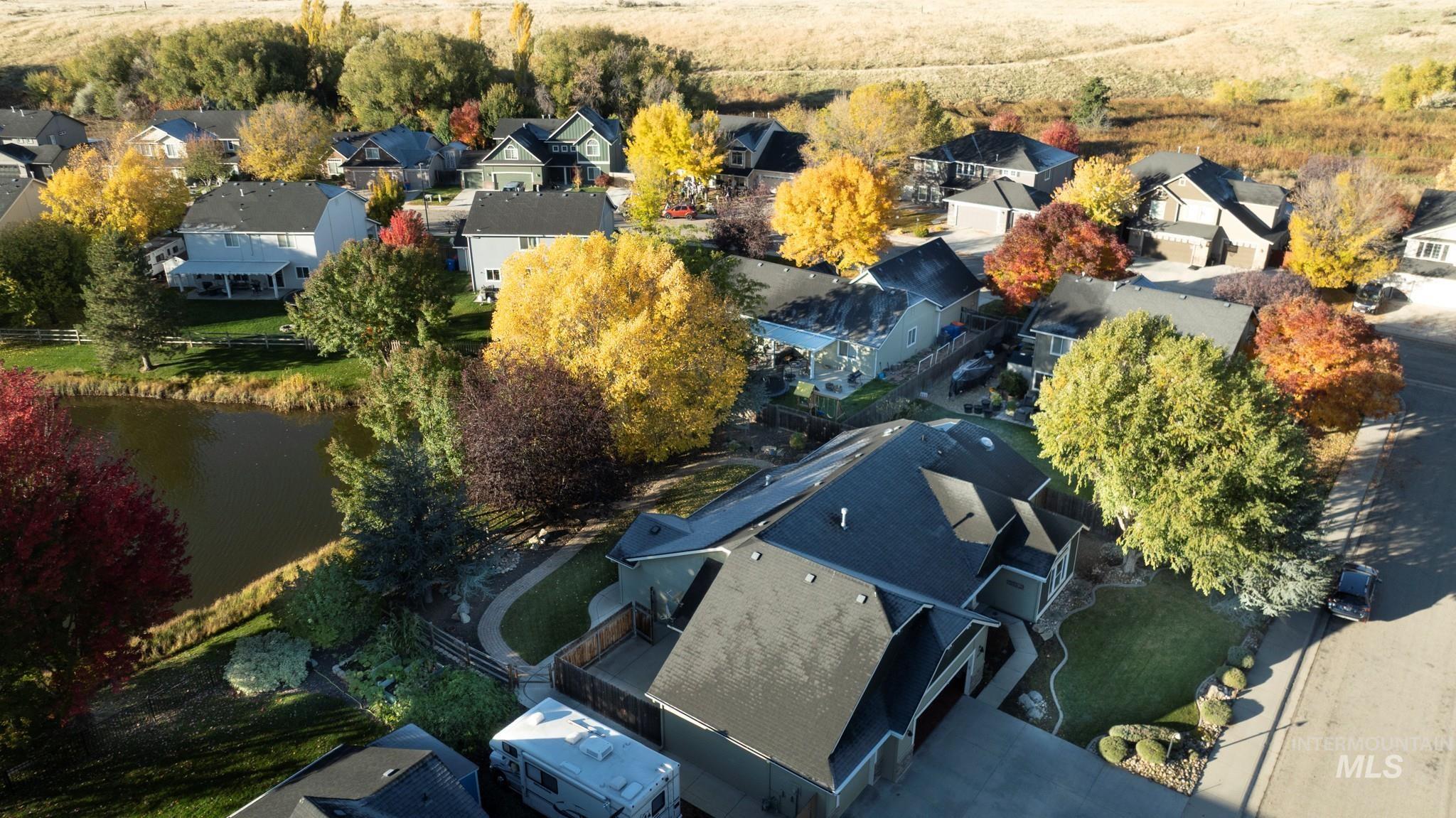Aerial perspective of suburban area with a nearby body of water