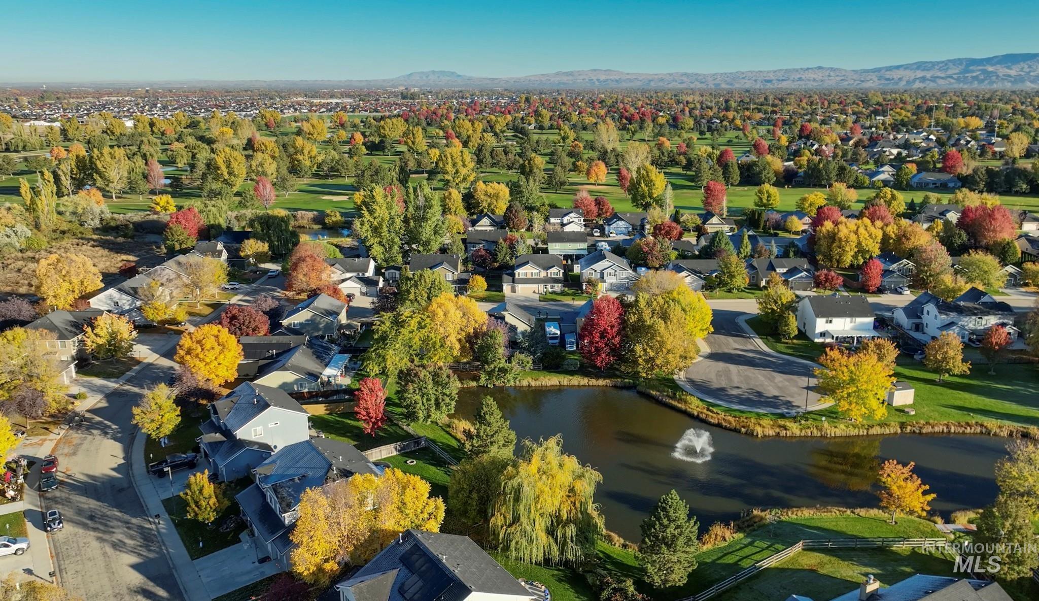 Aerial view of residential area featuring a water and mountain view