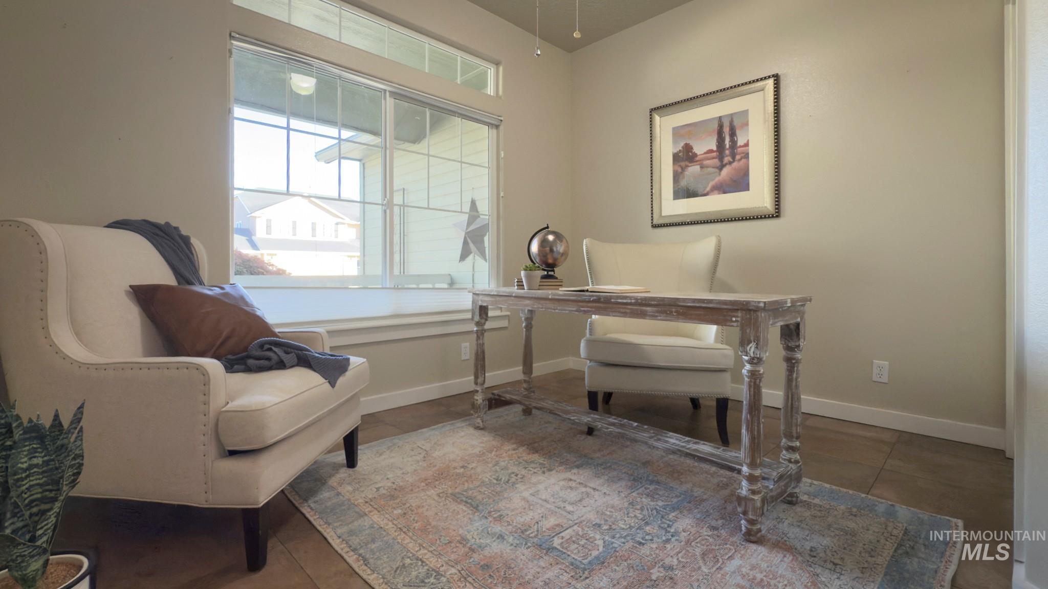 Office with baseboards and tile patterned flooring