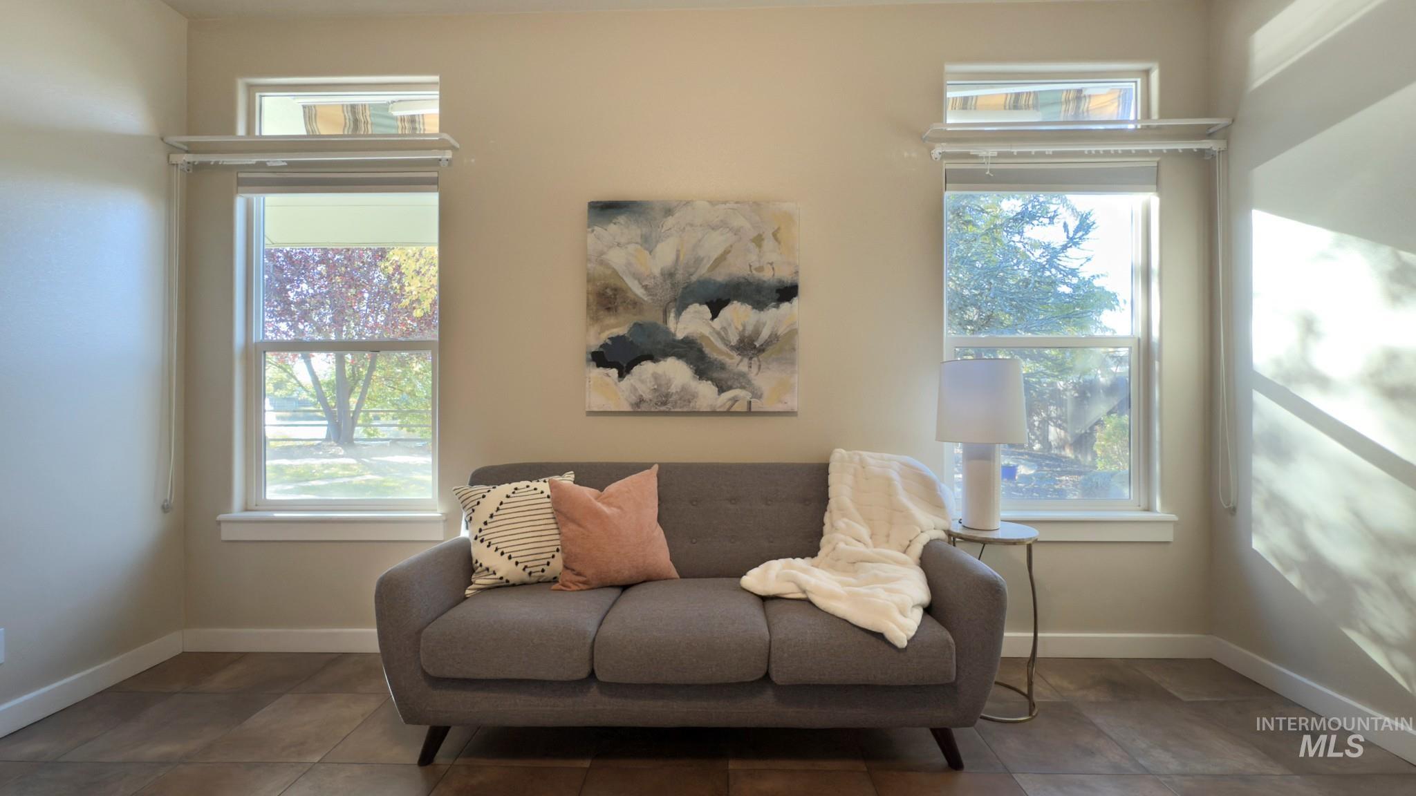 Living area with baseboards and tile patterned flooring