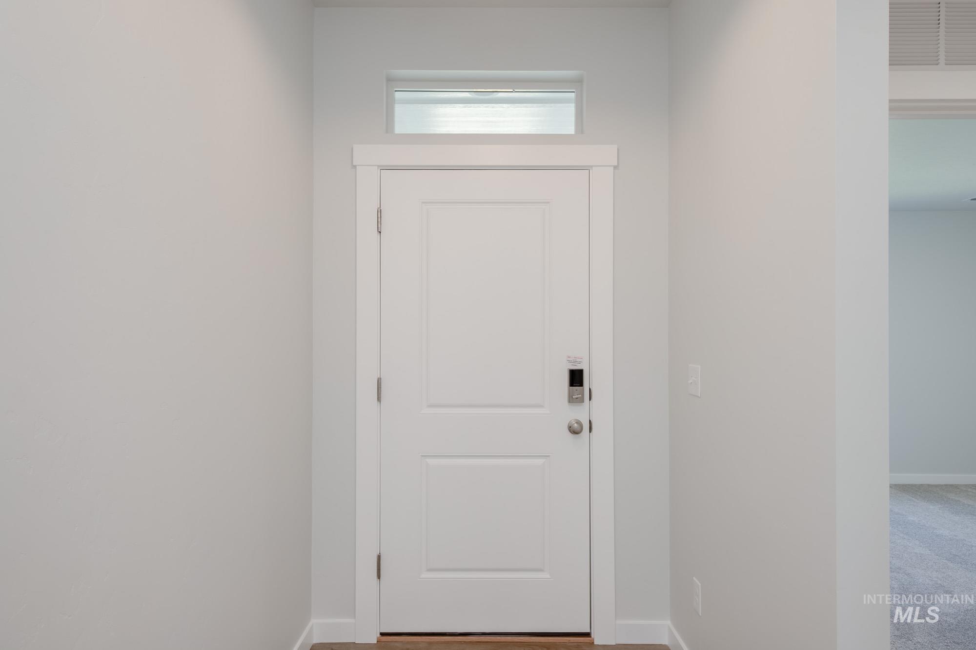 Doorway to outside featuring baseboards
