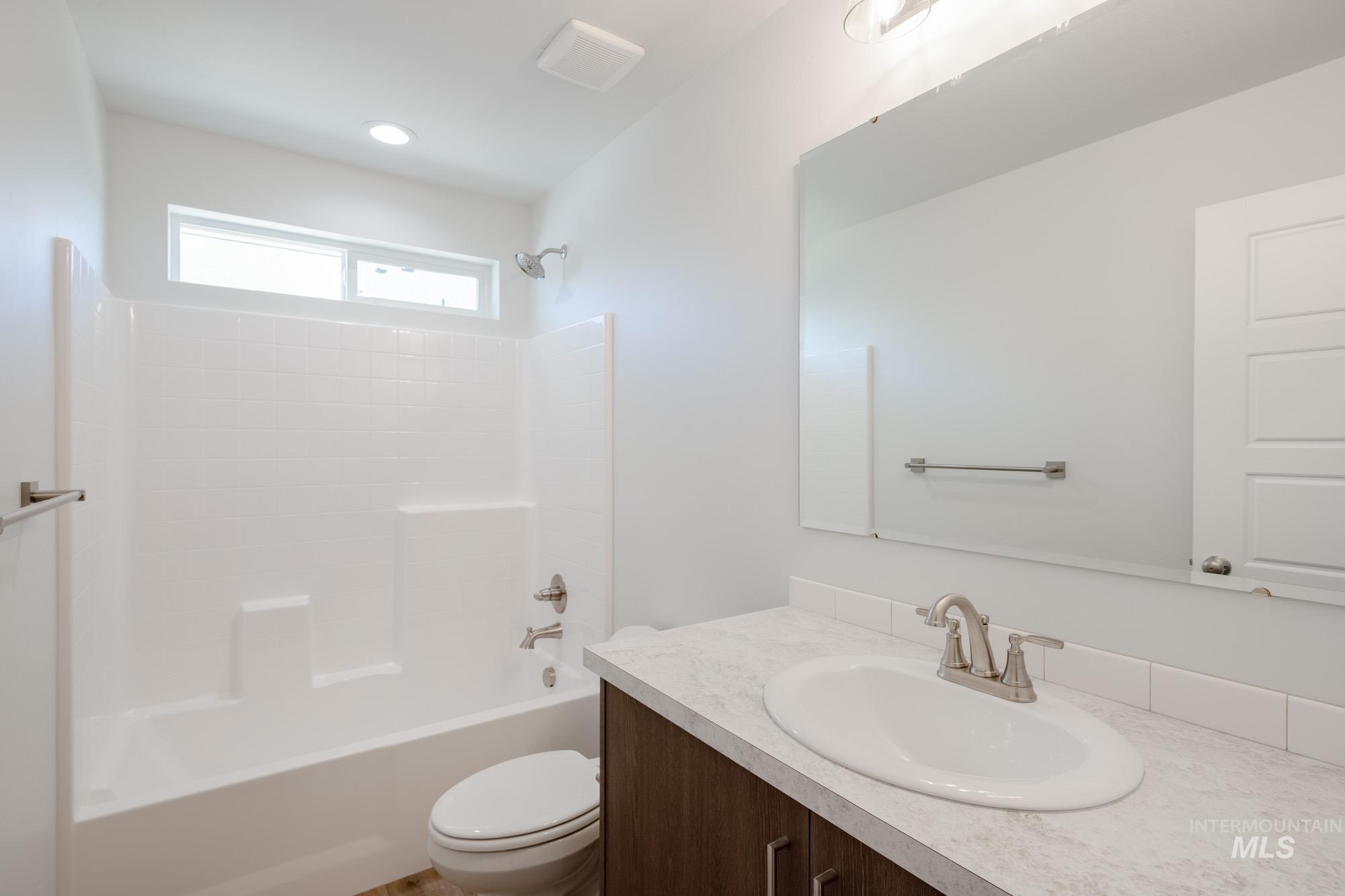 Bathroom featuring vanity and  shower combination