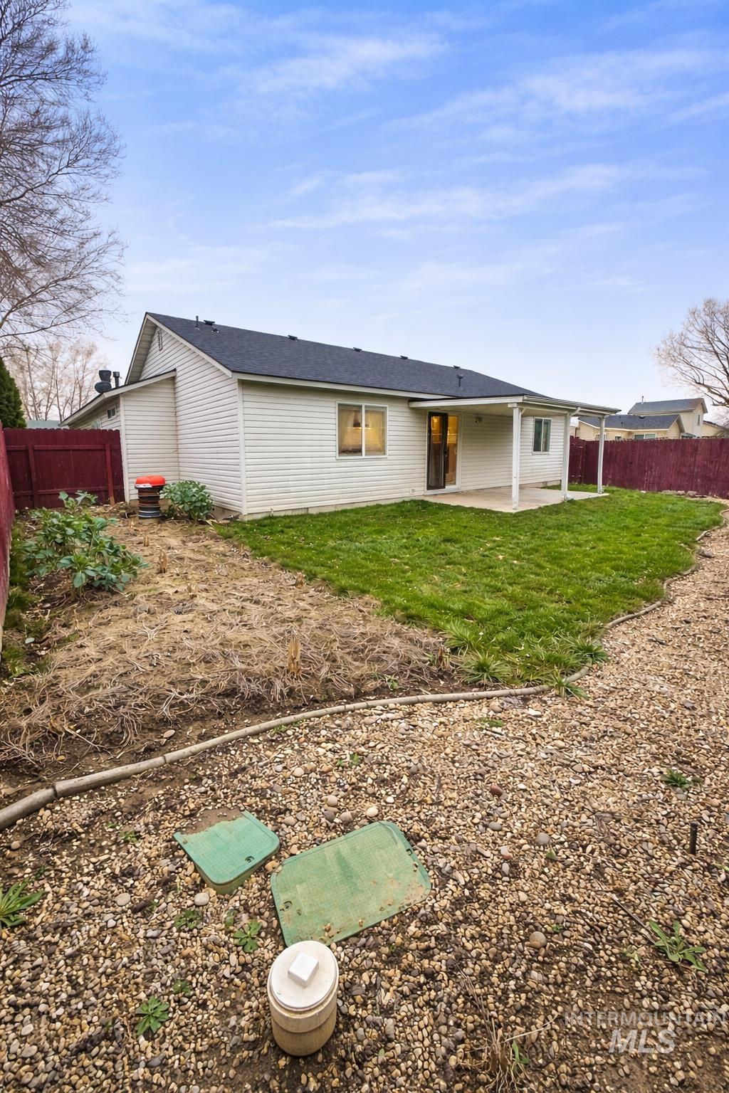 Rear view of property featuring a patio and a fenced backyard