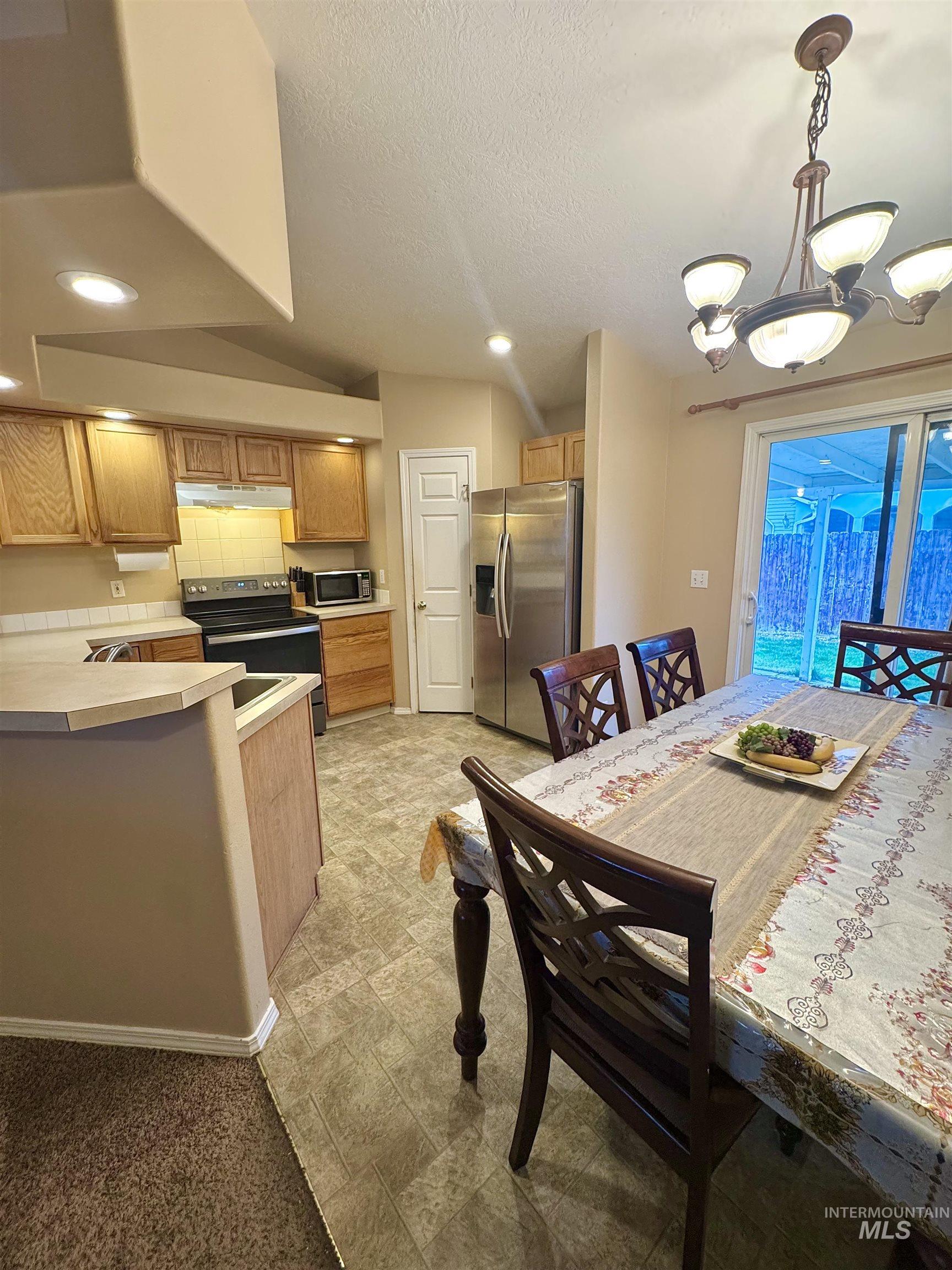 Dining room with a chandelier and a textured ceiling