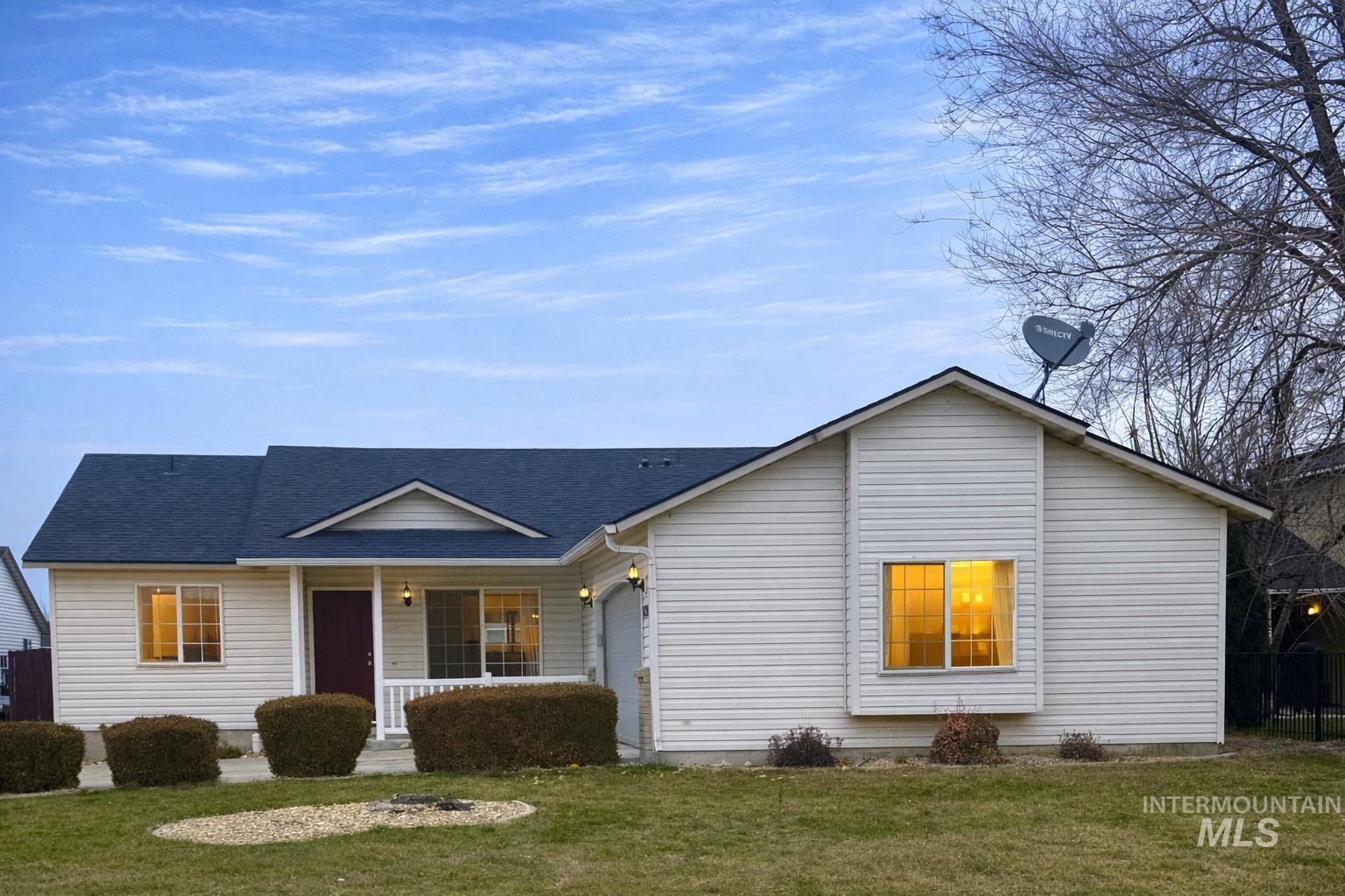 View of front of home featuring covered porch, a front yard, and roof with shingles