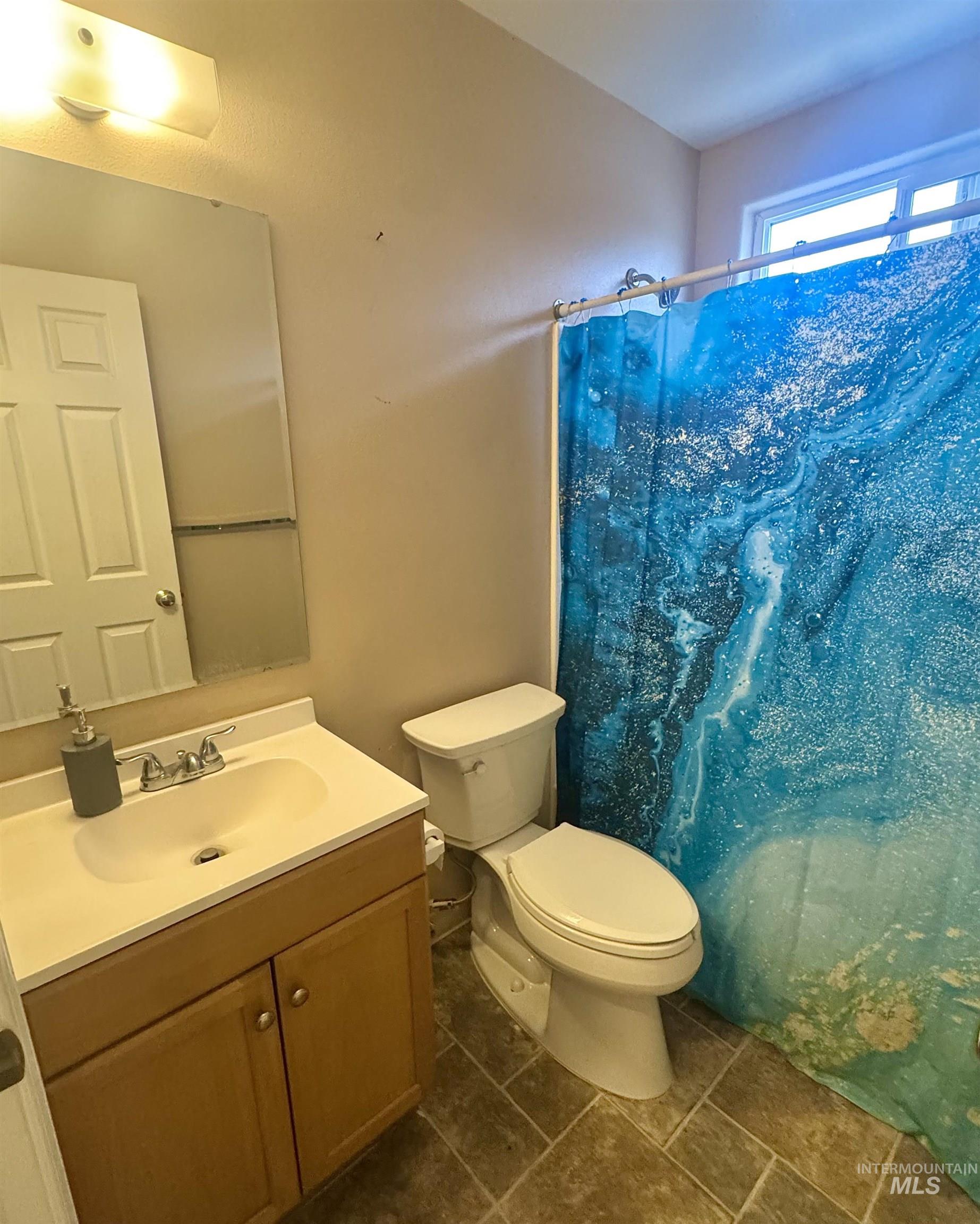 Bathroom featuring vanity and a shower with curtain