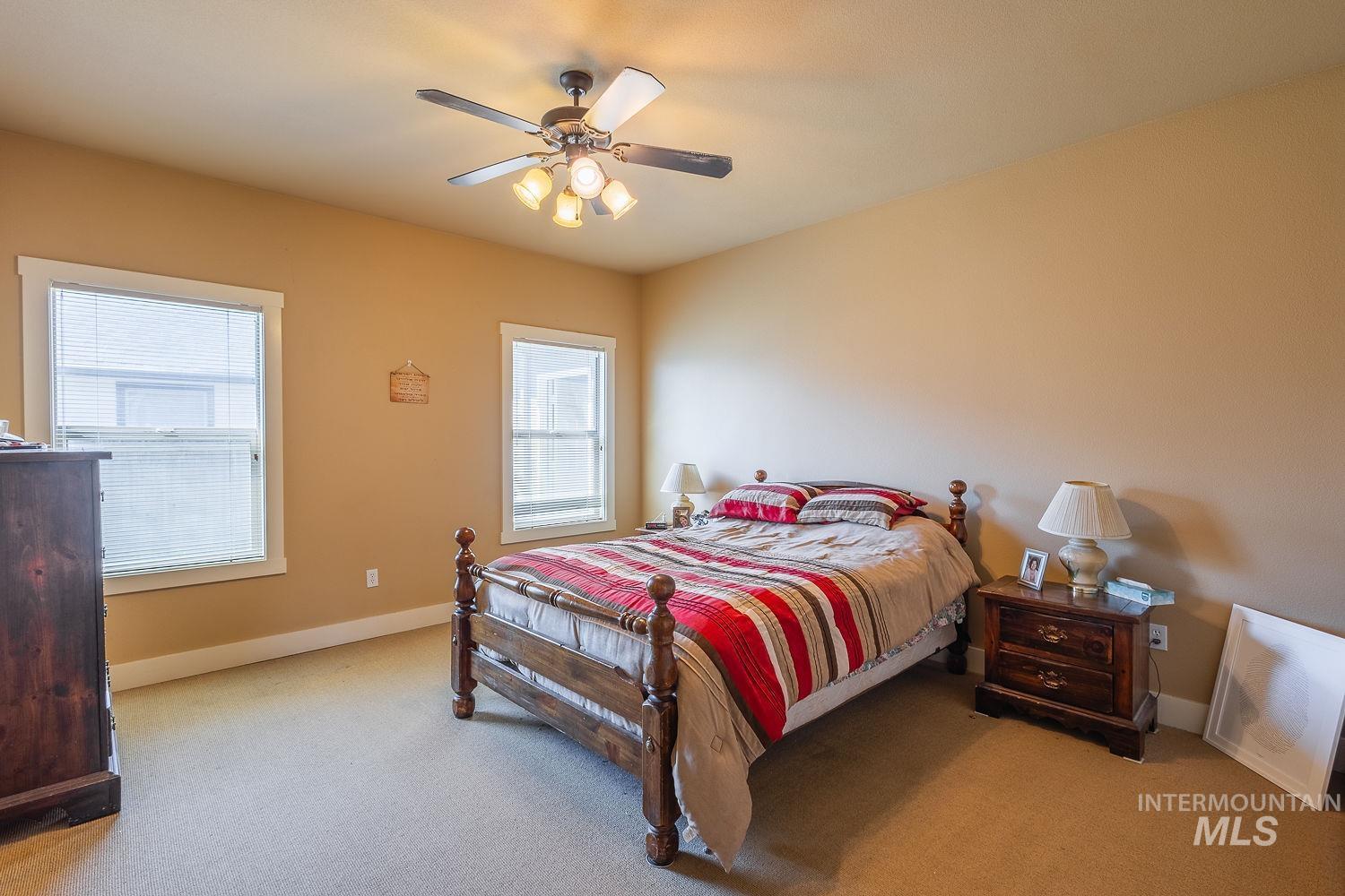 Bedroom with carpet flooring and a ceiling fan