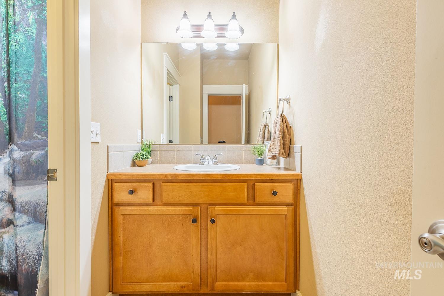 Bathroom with vanity and decorative backsplash