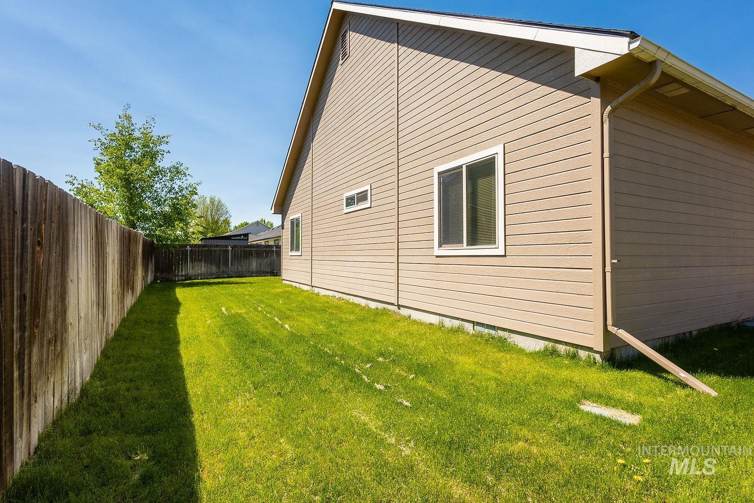 View of property exterior with a fenced backyard