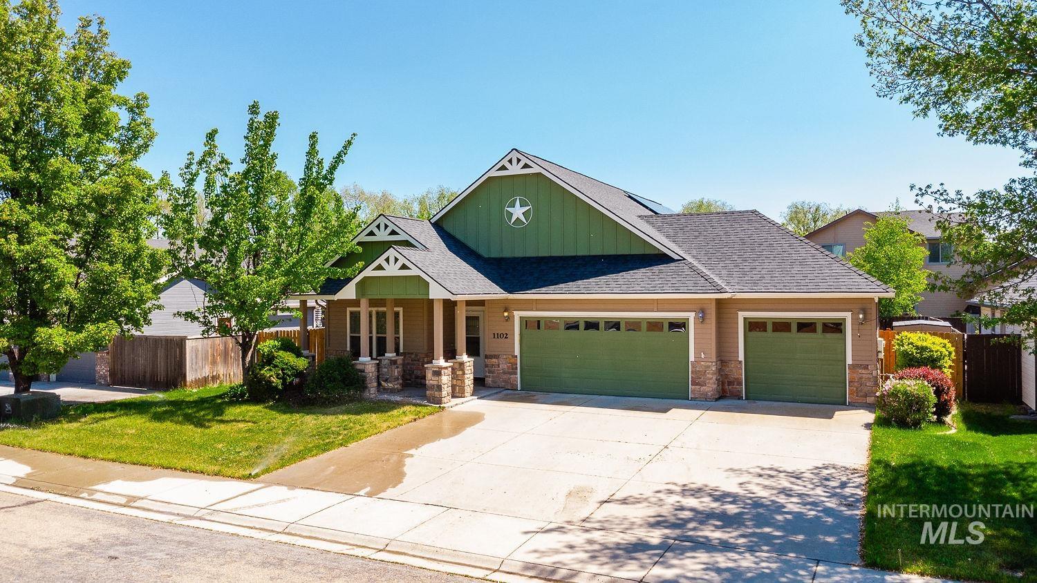 Craftsman house featuring board and batten siding, a garage, covered porch, roof with shingles, and concrete driveway
