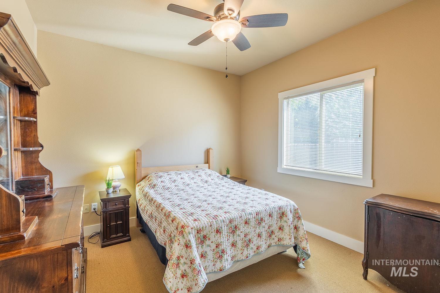 Bedroom with carpet floors and a ceiling fan
