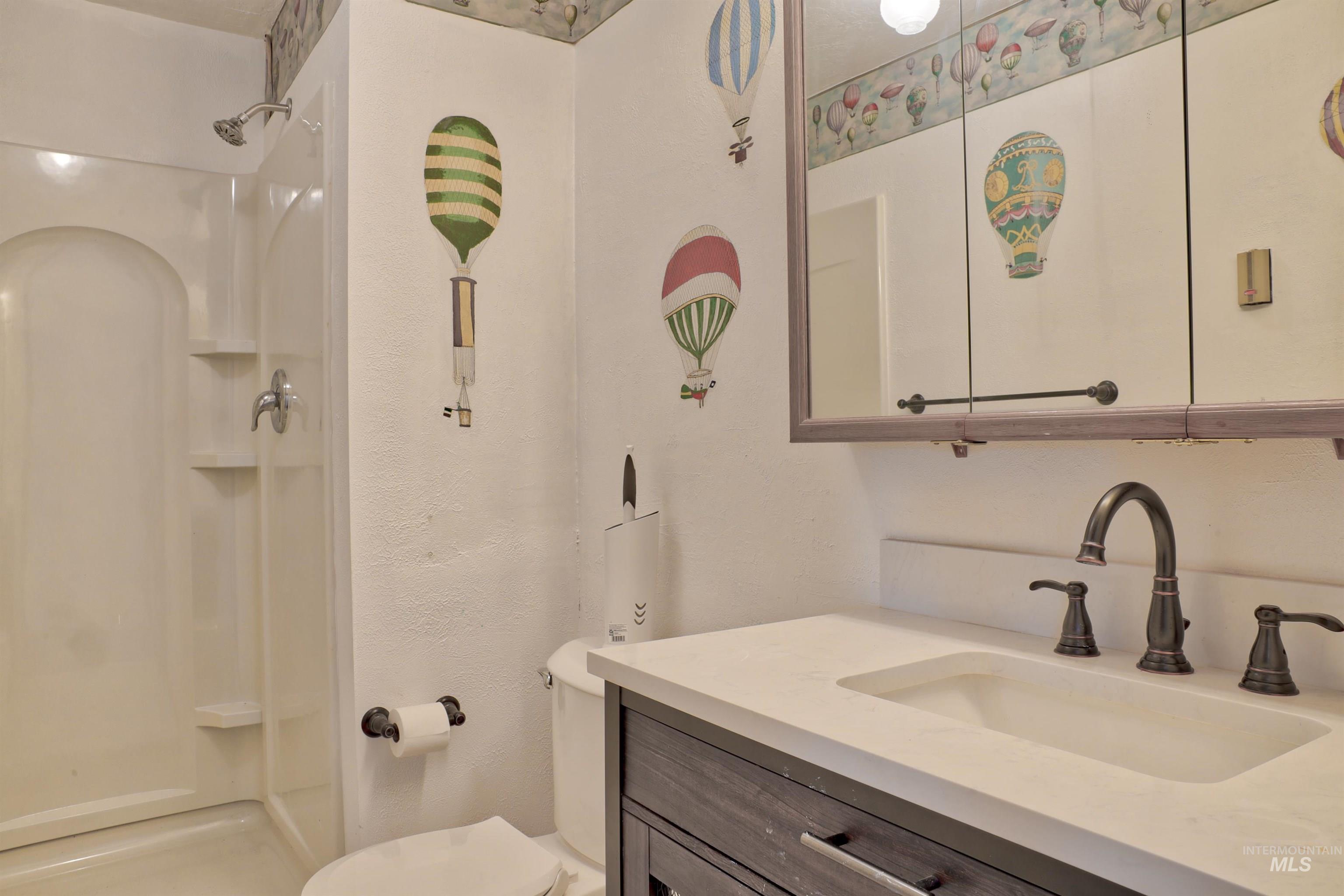 Full bath featuring vanity and a shower stall