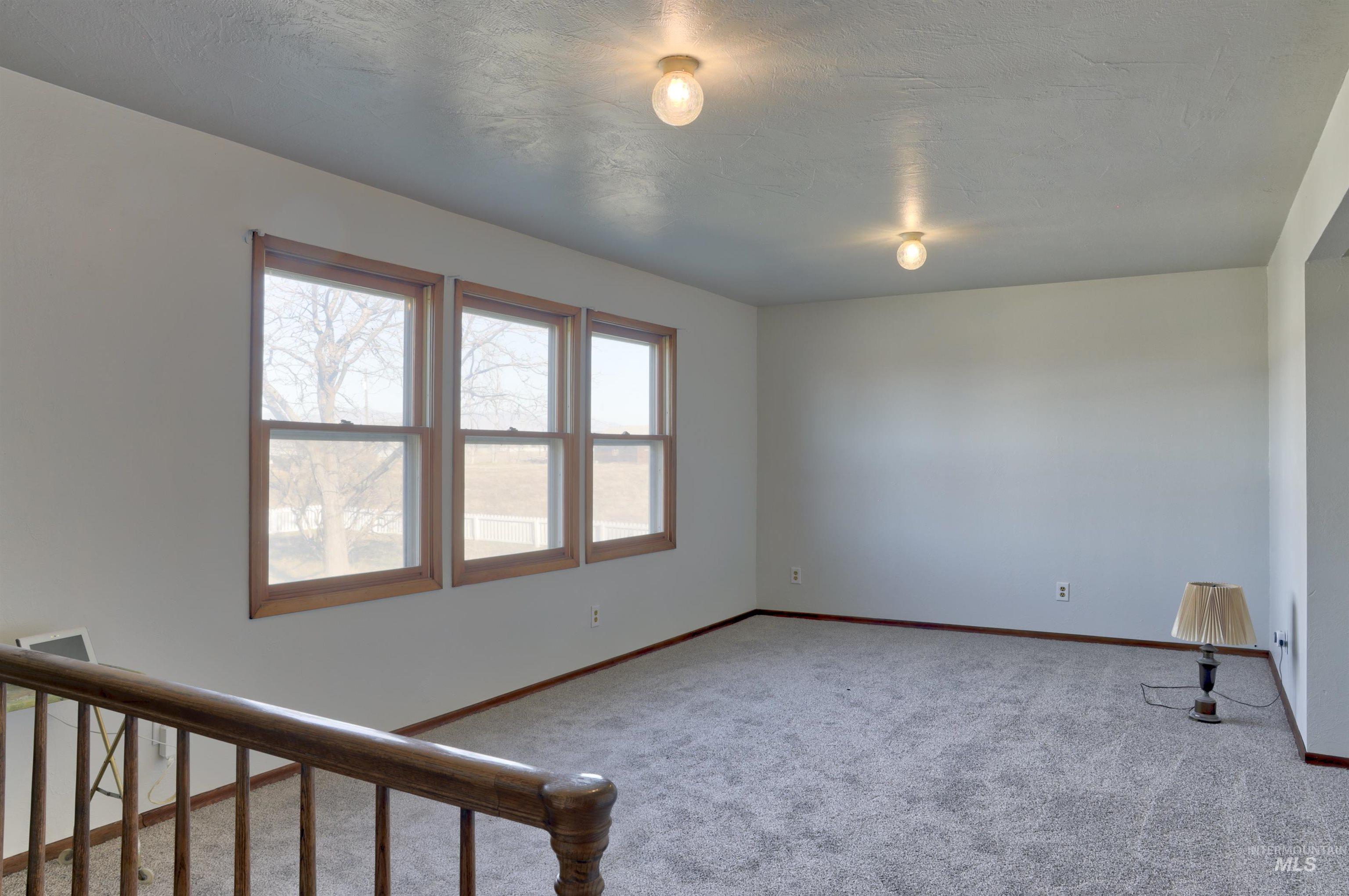 Unfurnished room featuring light colored carpet and baseboards
