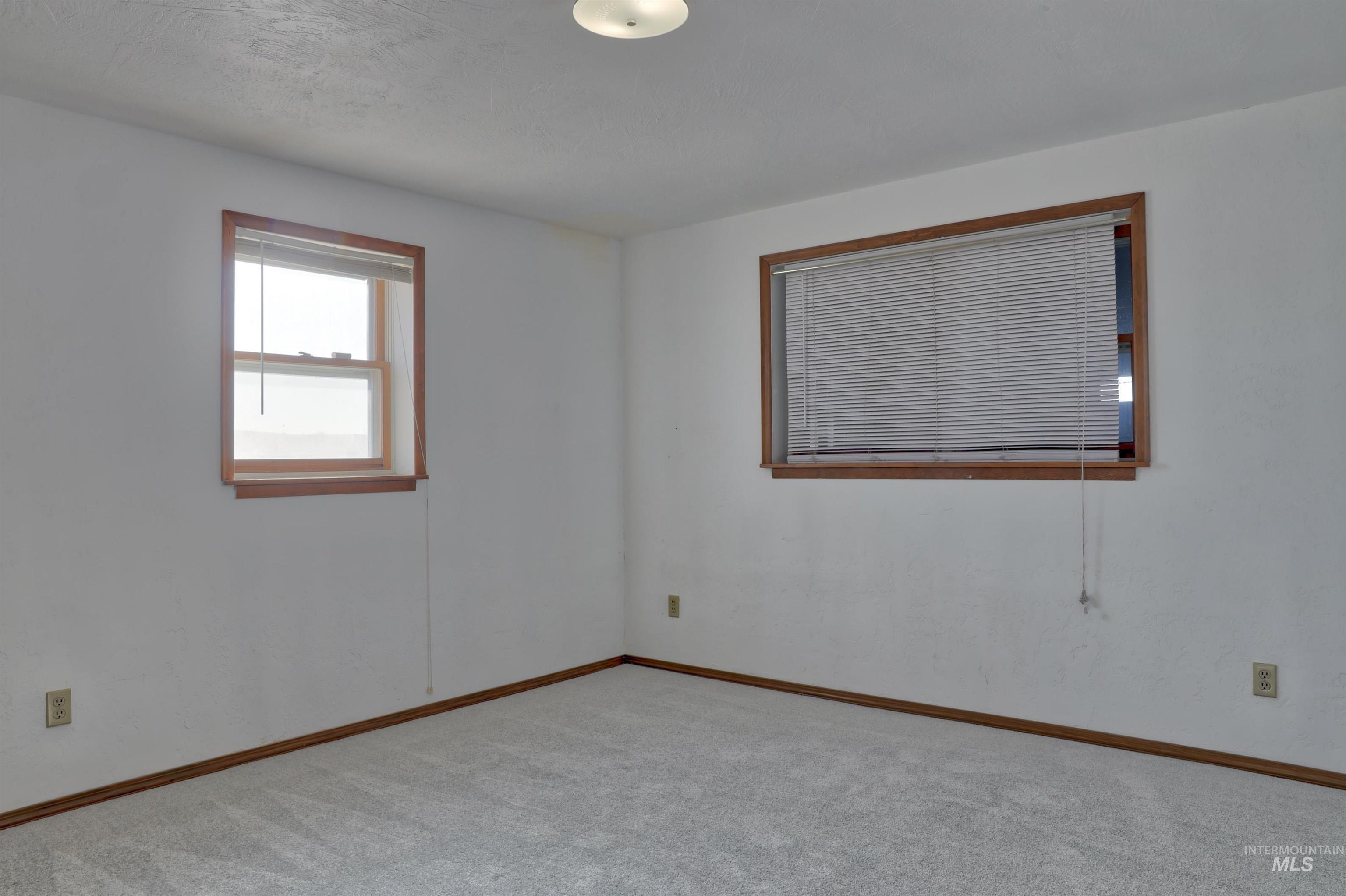 Unfurnished room featuring carpet floors and baseboards