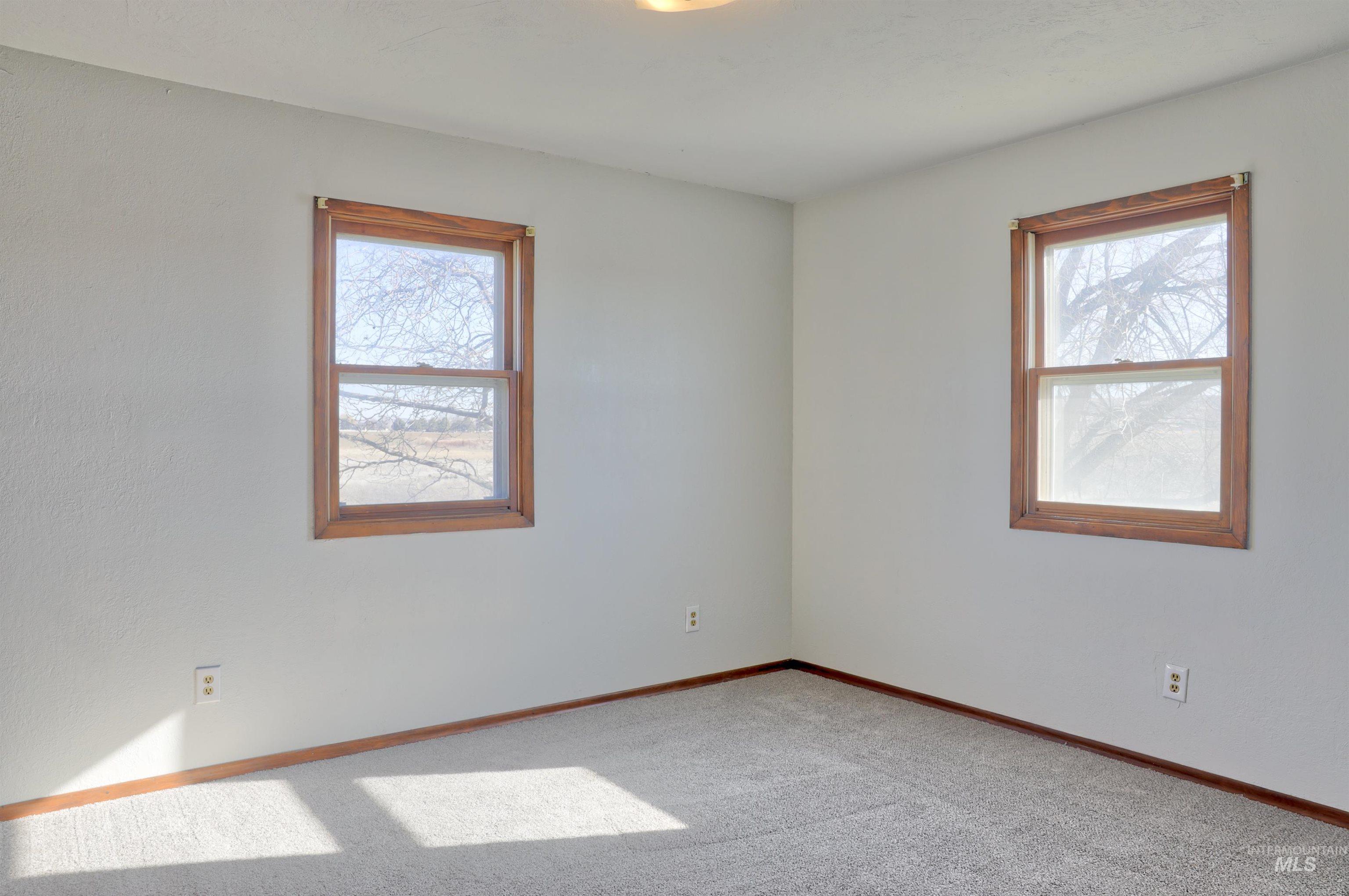 Carpeted empty room with baseboards